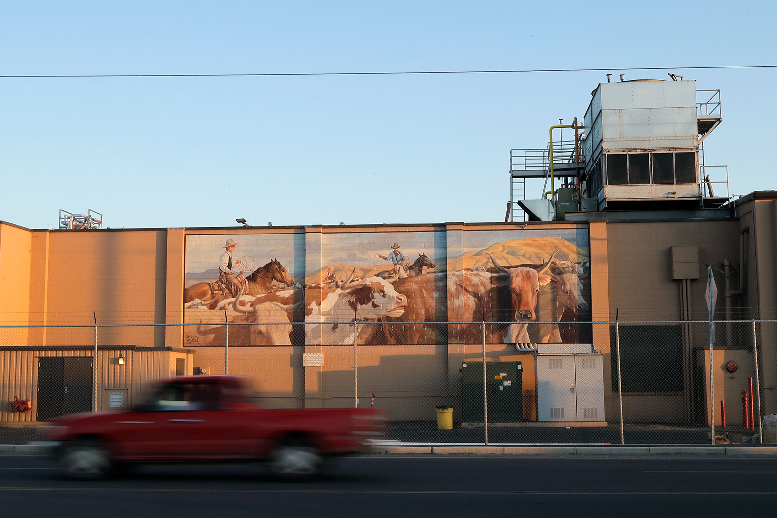 A truck passes by the Agri Beef processing plant in Toppenish, Washington, on Thursday, May 7. Twenty state attorneys general sent a letter to the White House Tuesday asking for "immediate action to ensure the safety of these essential workers" at meat and poultry plants across the country. 