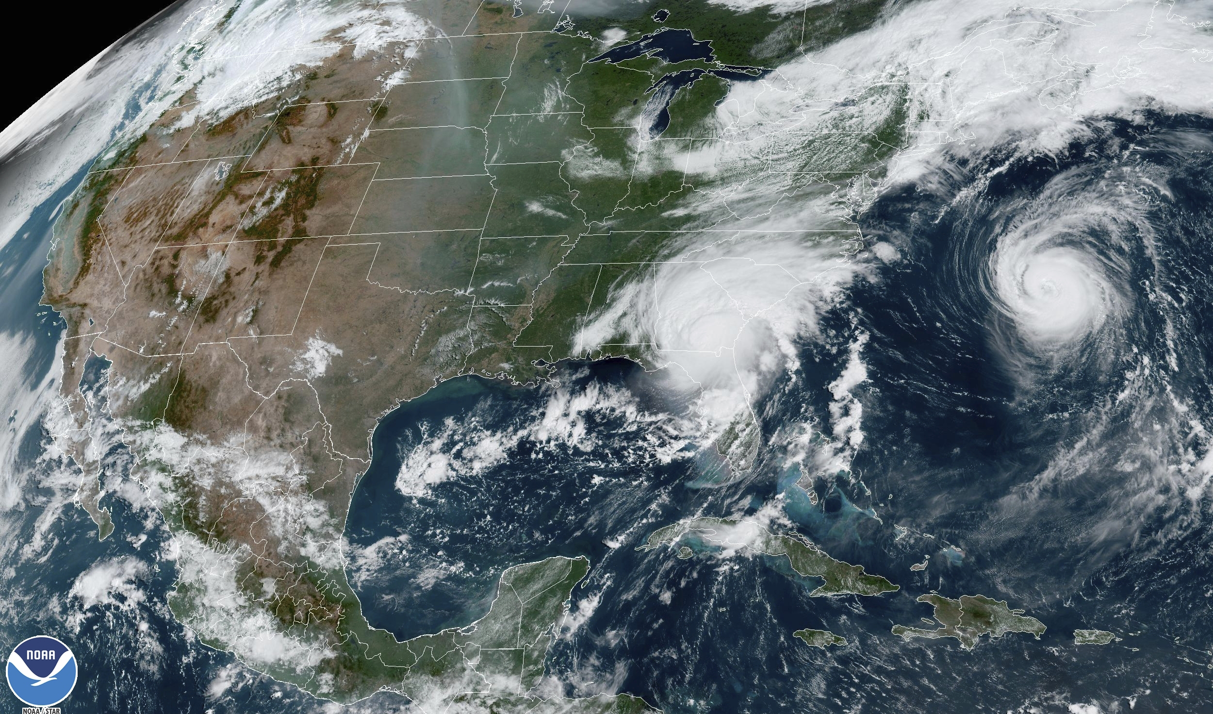 This satellite image from 11:21 a.m. EDT shows Hurricane Idalia, center, over Florida and crossing into Georgia, and Hurricane Franklin, right, as it moves along off the East coast of the United States on August 30.