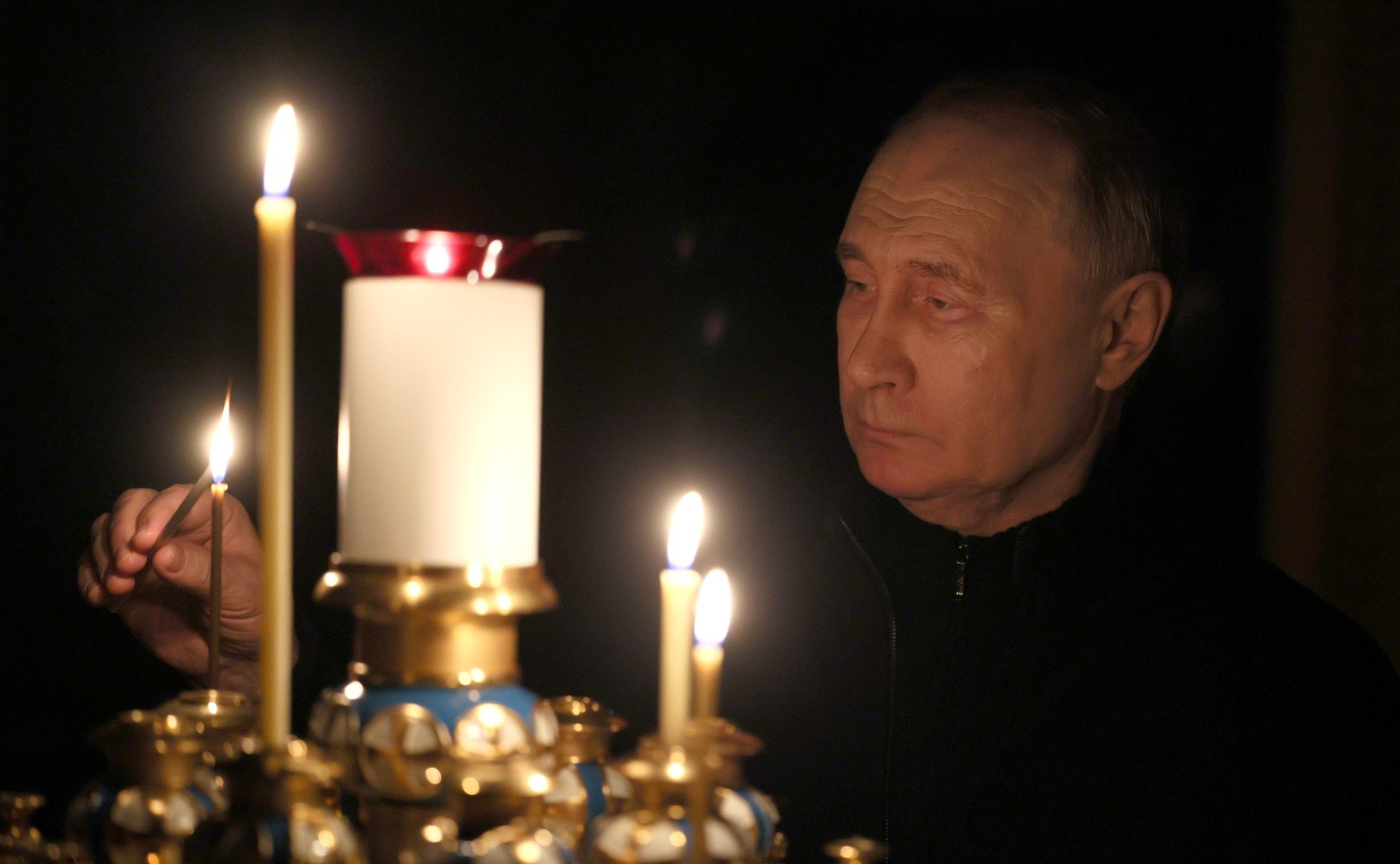 In this photo from the Kremlin, Russian President Vladimir Putin lights a candle in memory of victims of the Crocus City Hall attack, at the Novo-Ogaryovo residence in the Moscow region, on March 24.