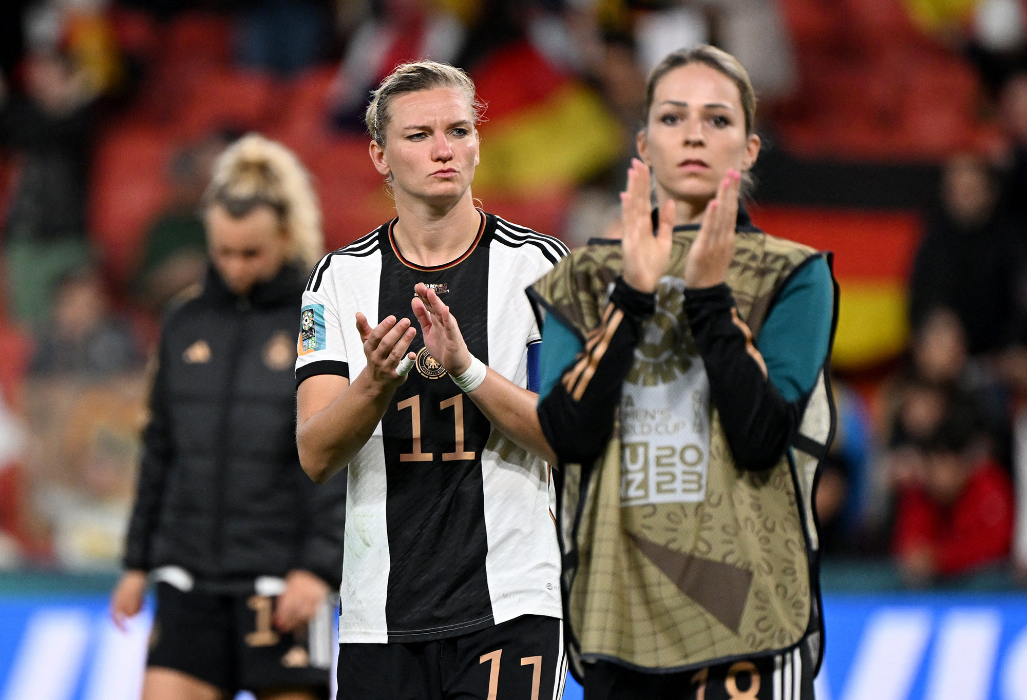 Germany's Alexandra Popp, center, and Melanie Leupolz applauds fans after Germany are knocked out of the World Cup at Brisbane Football Stadium, in Brisbane, Australia, on August 3.