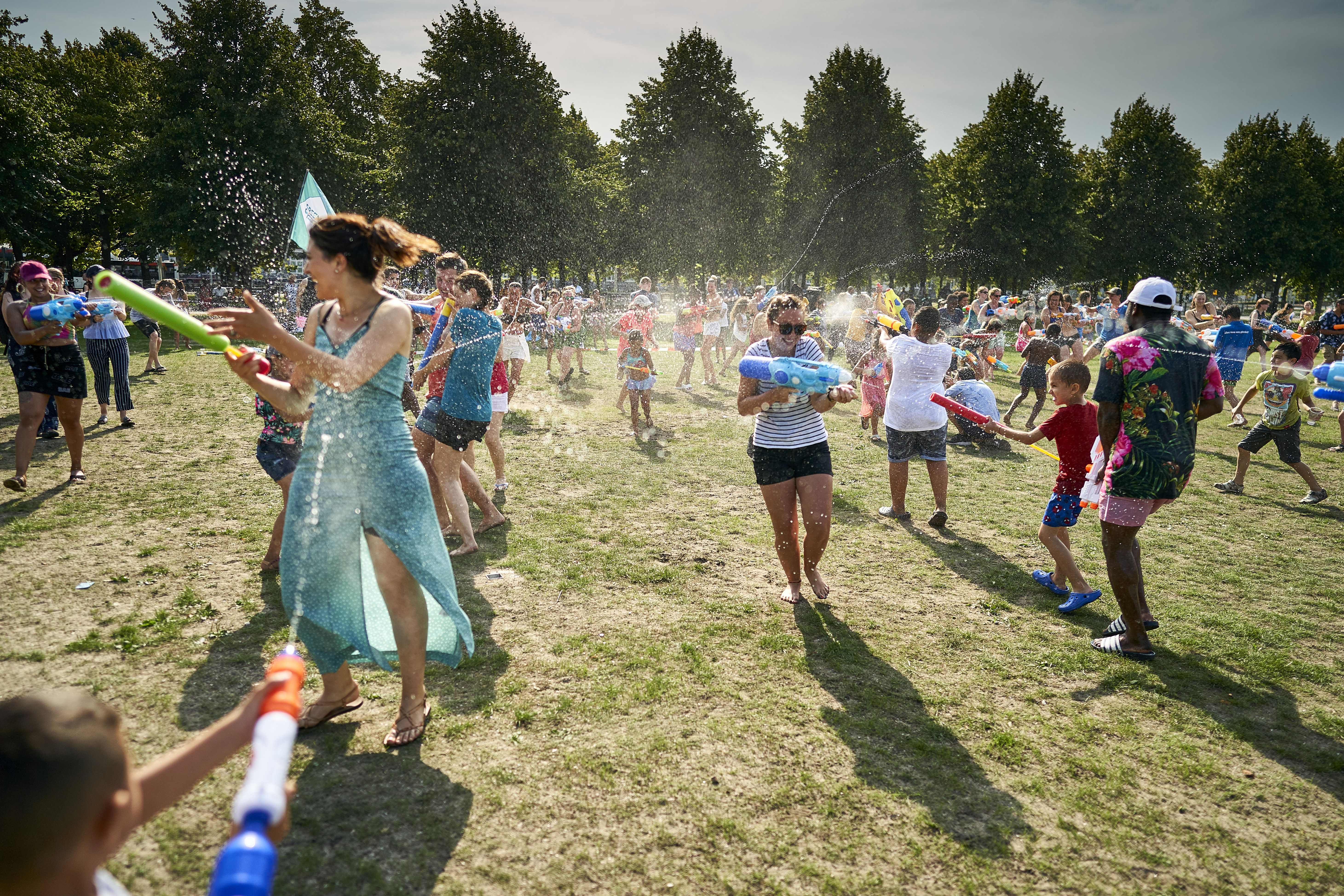 People cool off with a water fight on the Malieveld, in The Hague city center, on Wednesday. (Phil Nijhuis/AFP/Getty Images)