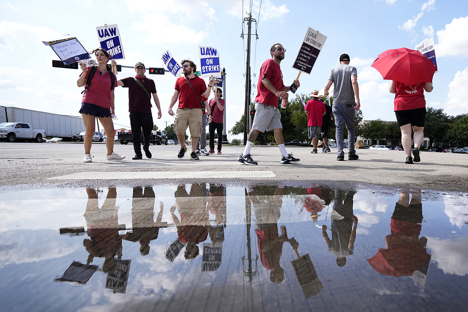 UAW union members picket on the street in front of a Stellantis distribution center, Monday, Sept. 25 in Carrollton, Texas.