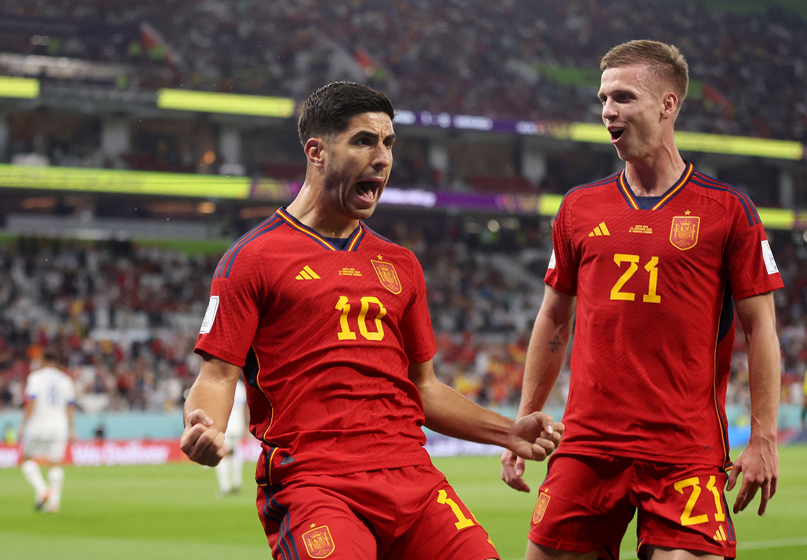 Spain's Marco Asensio, left, celebrates scoring their second goal with Dani Olmo during a match against Costa Rica on November 23.