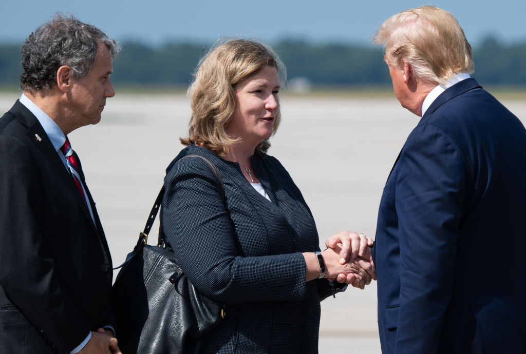 ]President Donald Trump (R) greets Dayton Mayor Nan Whaley (C) as he arrives at Wright-Patterson Air Force Base in Ohio on Aug. 7, 2019.