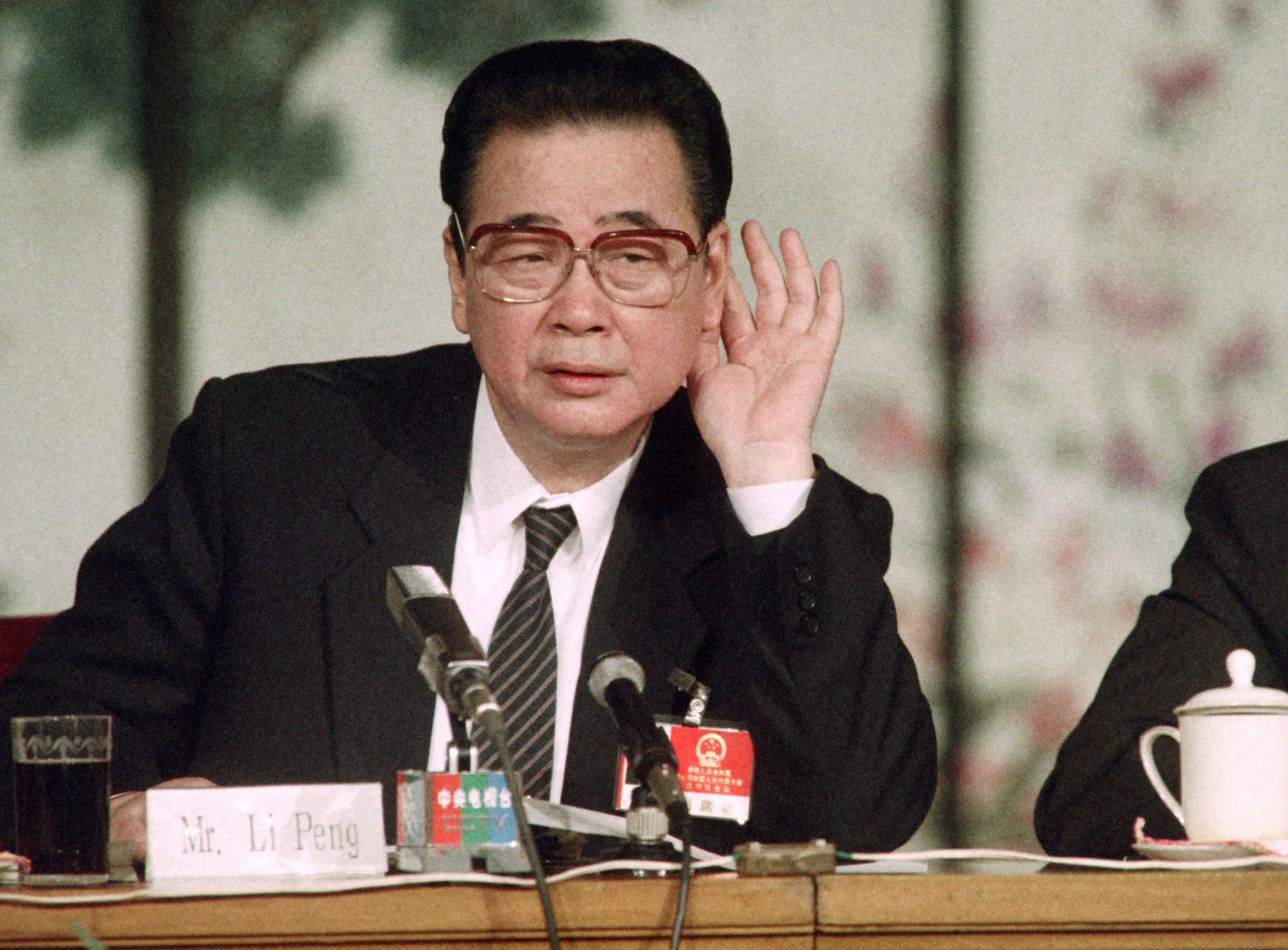 Chinese Prime Minister Li Peng as he tries to hear a question during a press conference after the closing of the National People's Congress on April 9, 1991.