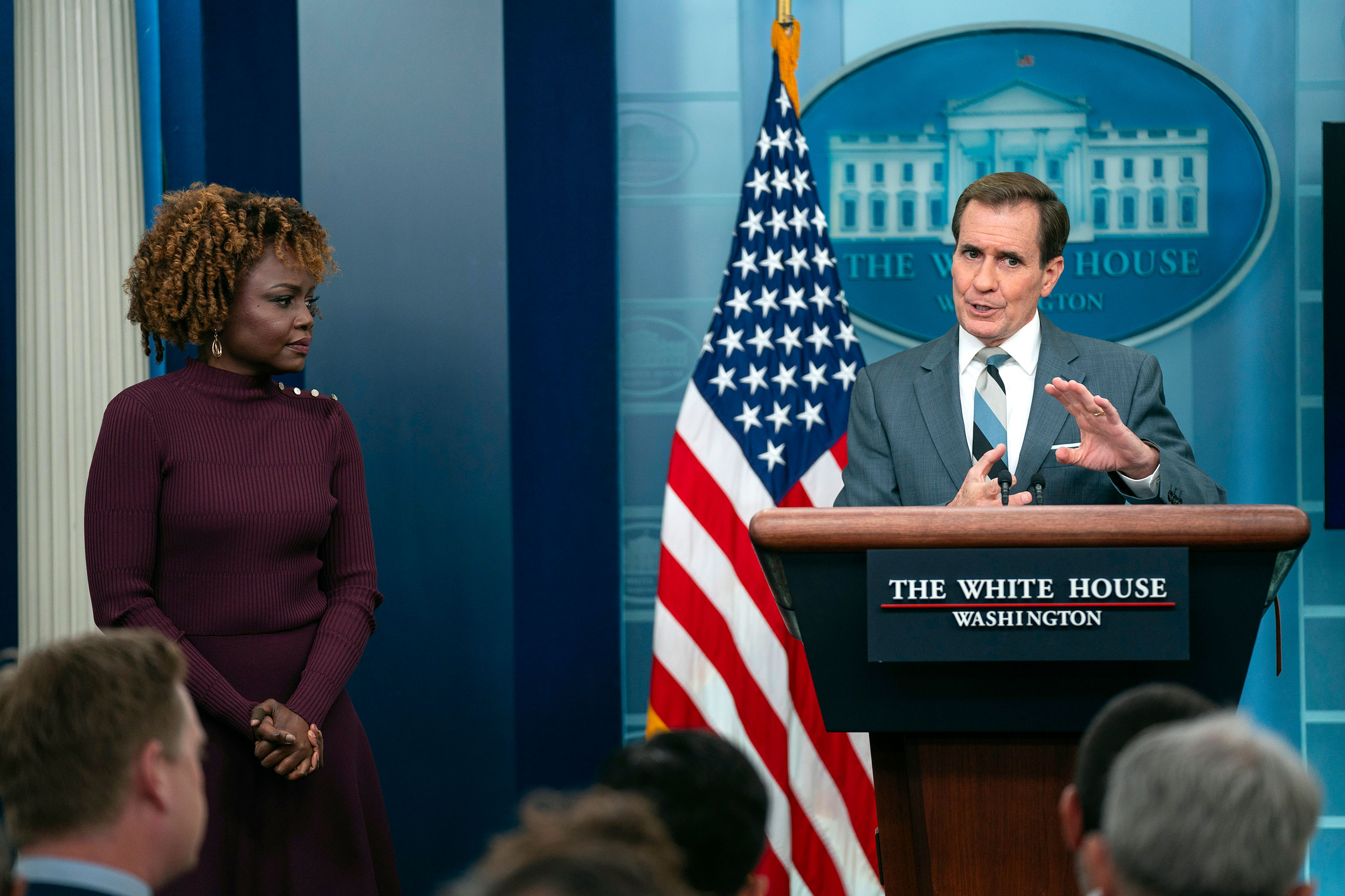 White House press secretary Karine Jean-Pierre listens as National Security Council spokesman John Kirby speaks during a briefing at the White House on Monday.
