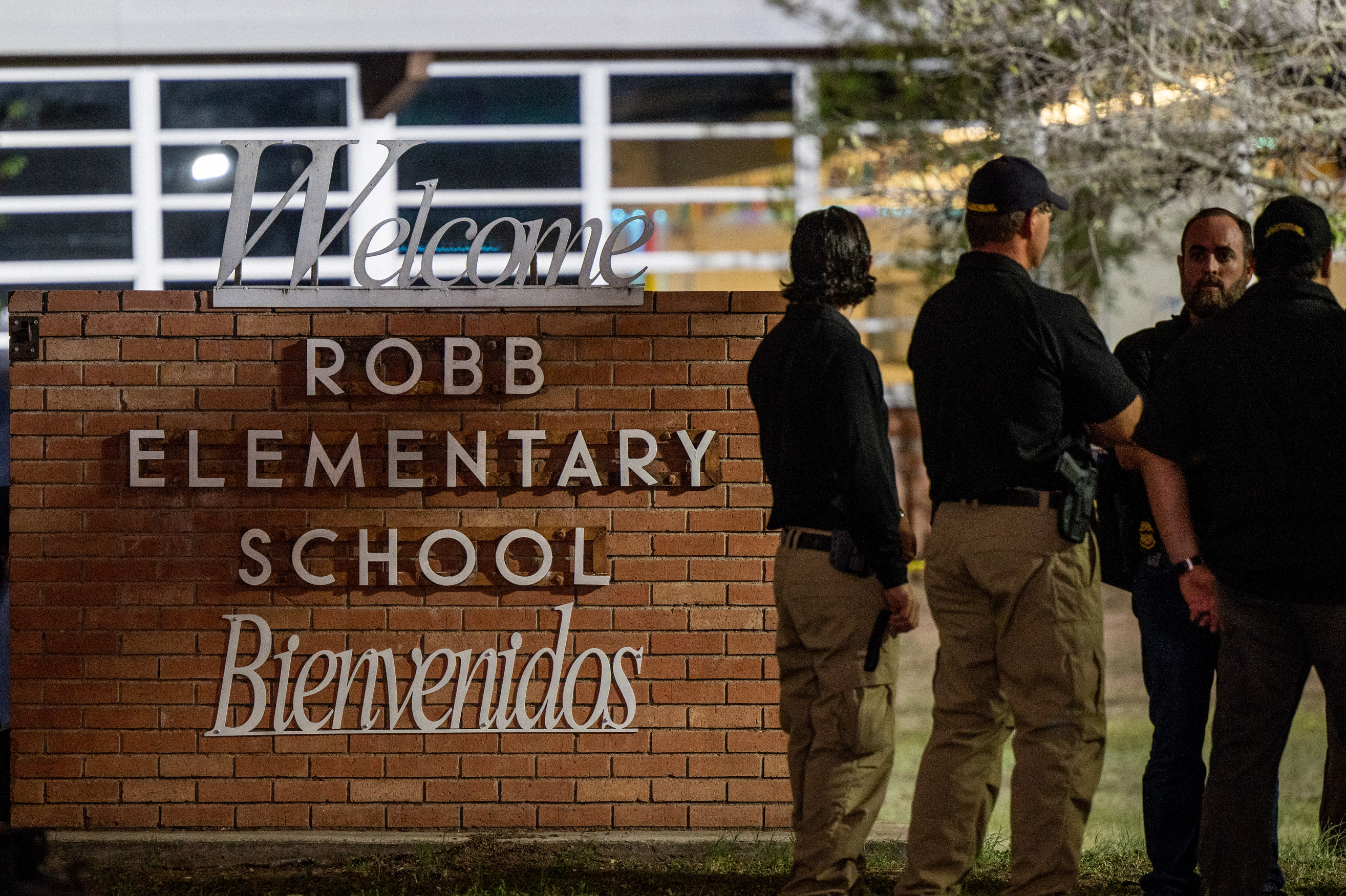 Law enforcement officers speak together outside of Robb Elementary School following the shooting on May 24, in Uvalde, Texas. 