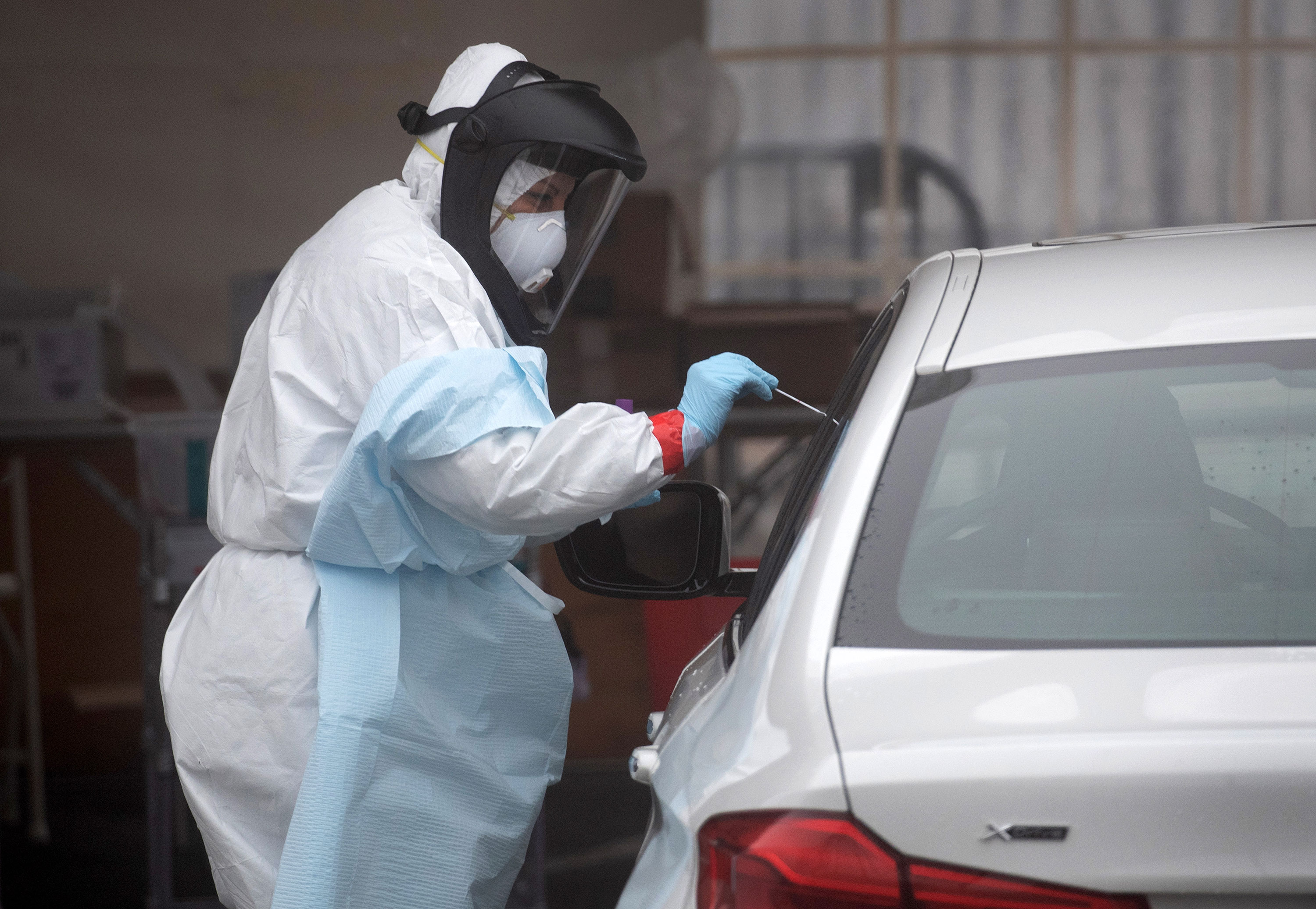 A health worker administers a test to a motorist in Stamford, Connecticut, on March 20.