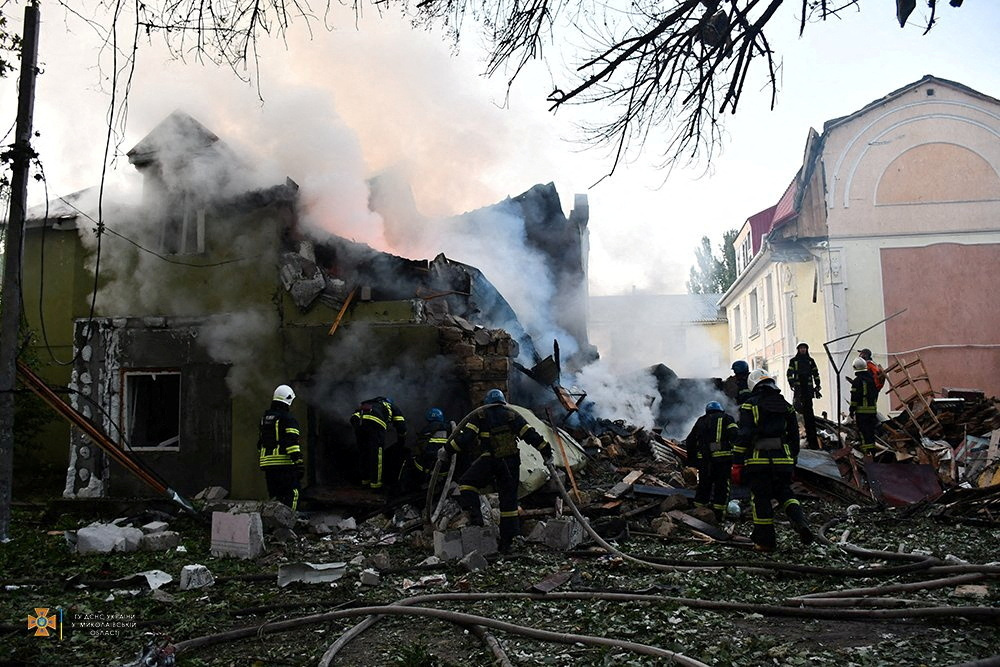 Firefighters work at a residential building damaged by a Russian military strike, in Mykolaiv, on Tuesday.