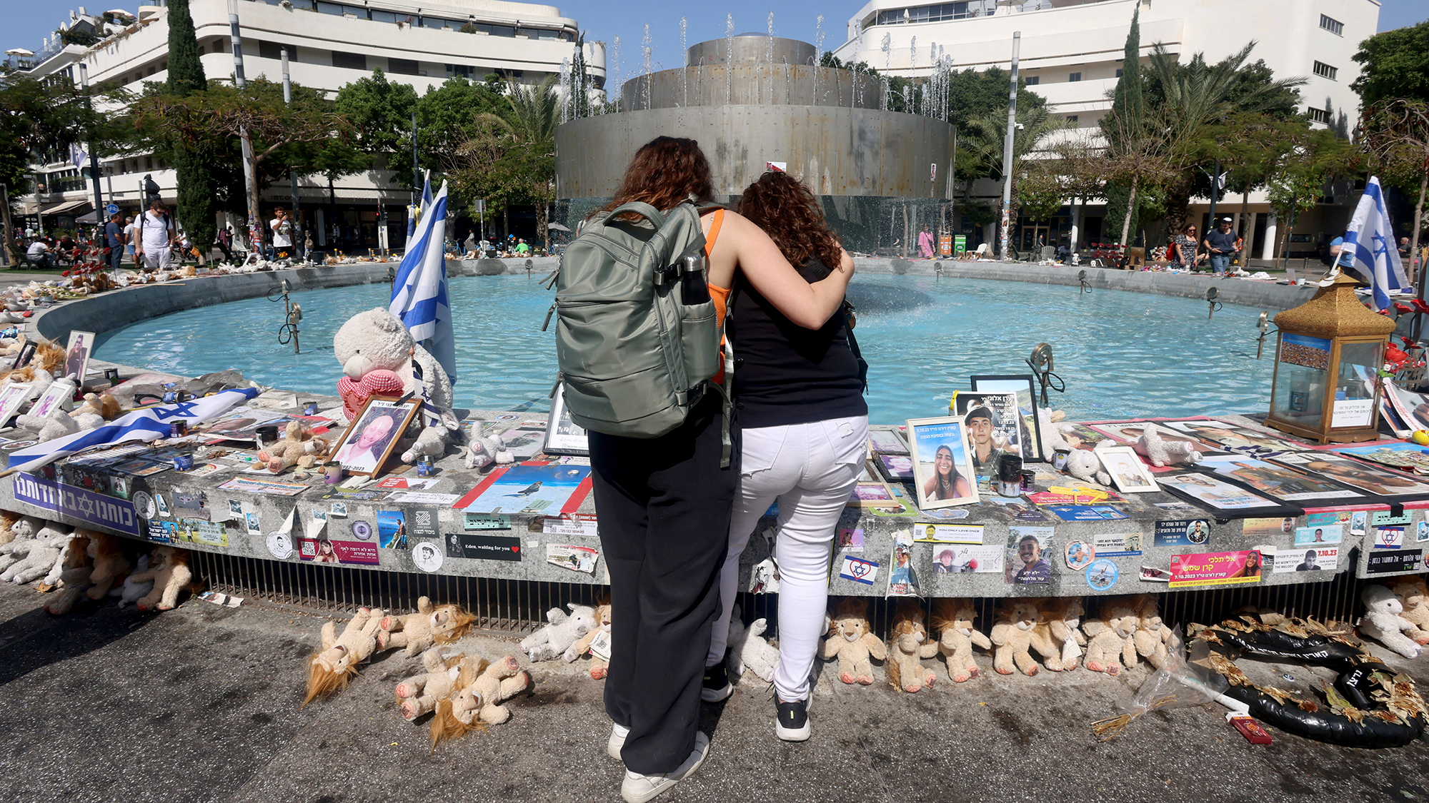 People look at memorabilia and pictures of hostages kidnapped by Hamas, displayed at a public square in Tel Aviv, Israel, on March 31. 