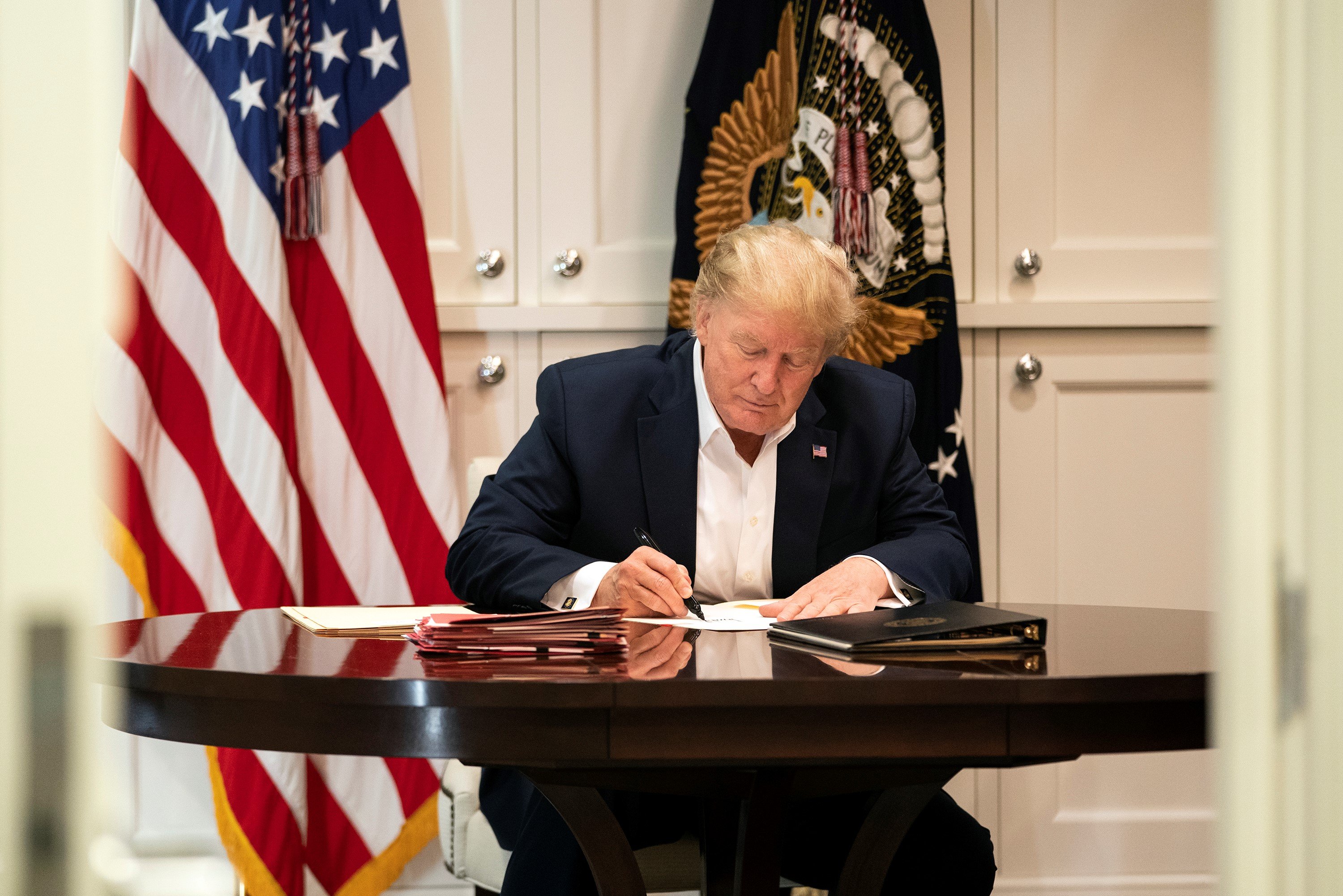 President Donald Trump works in the Presidential Suite at the Walter Reed National Military Medical Center in Bethesda, Maryland on Saturday, October 3. 