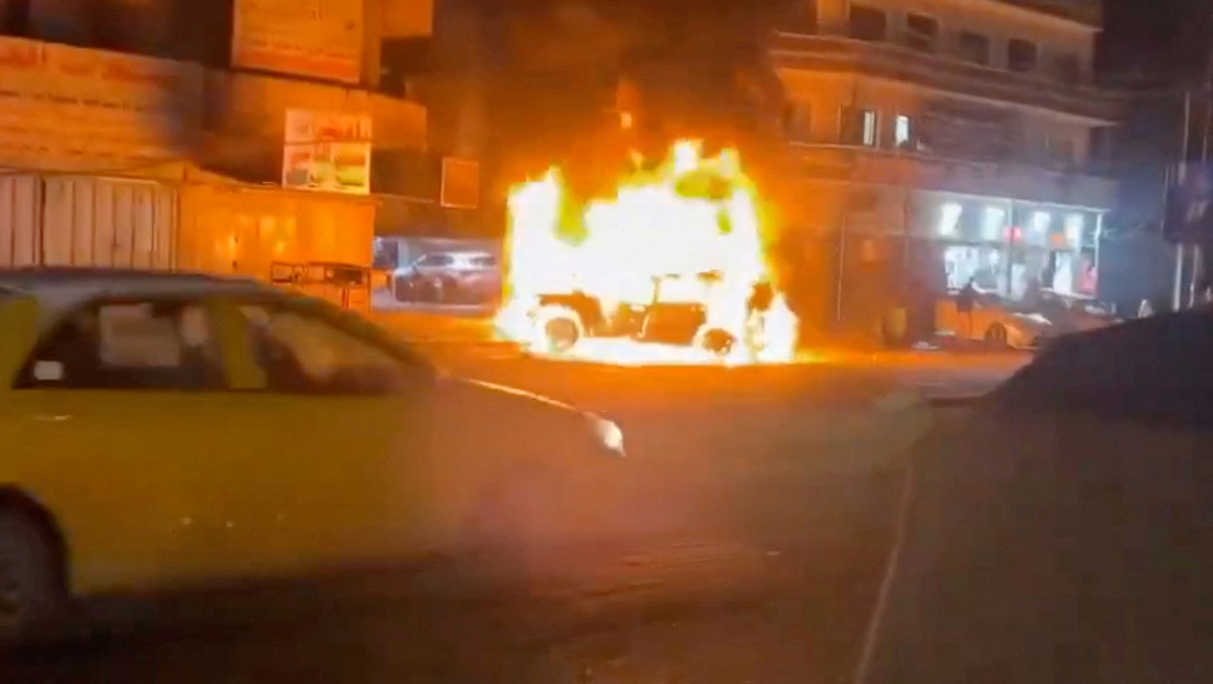A car burns, following what the U.S. military says was a deadly U.S. drone strike on a Kataib Hezbollah commander, in Baghdad, Iraq, on February 7, in this screengrab from social media video.