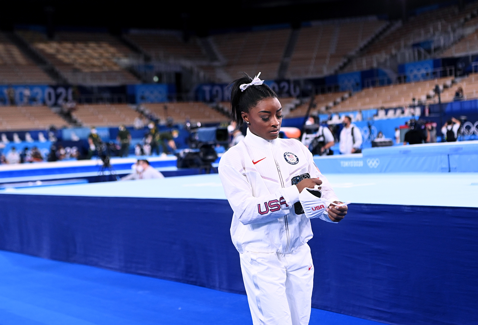 Simone Biles walks alone after the women's team final at the 2020 Tokyo Olympics. 