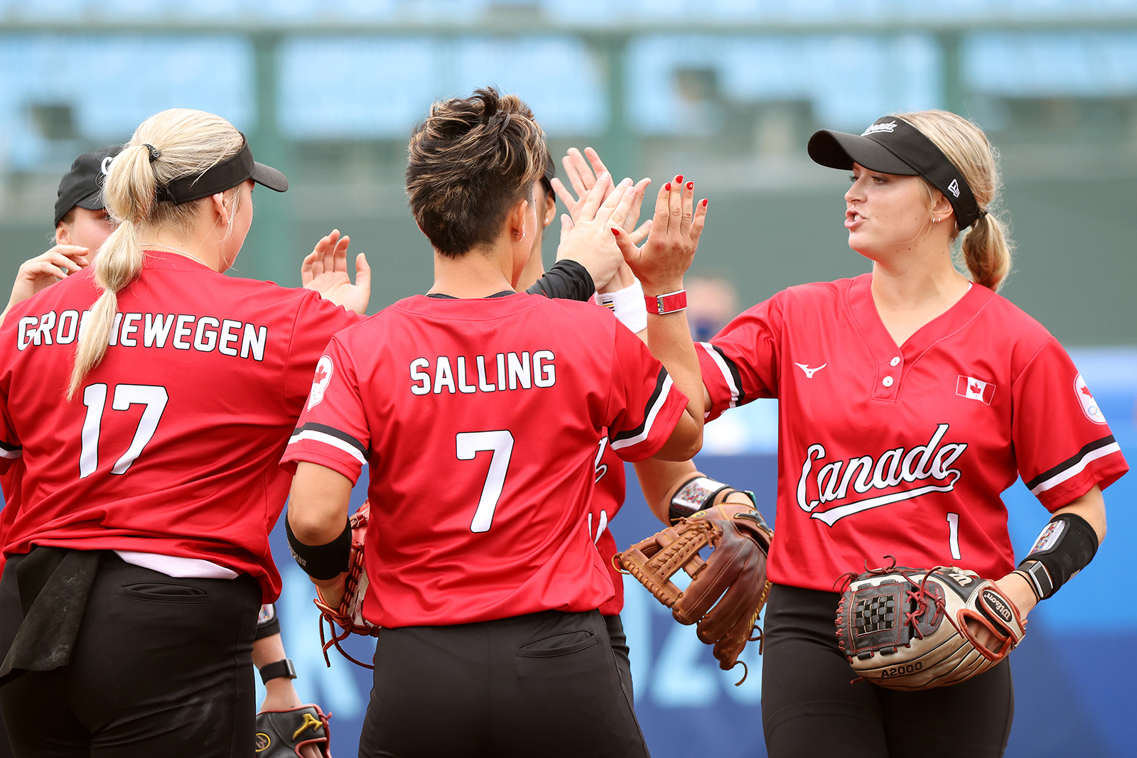 Kelsey Jenkins #1 of Team Canada high-fives teammates before their game against Team United States during the Softball Opening Round of the Tokyo 2020 Olympic Games at Fukushima Azuma Baseball Stadium on July 22.