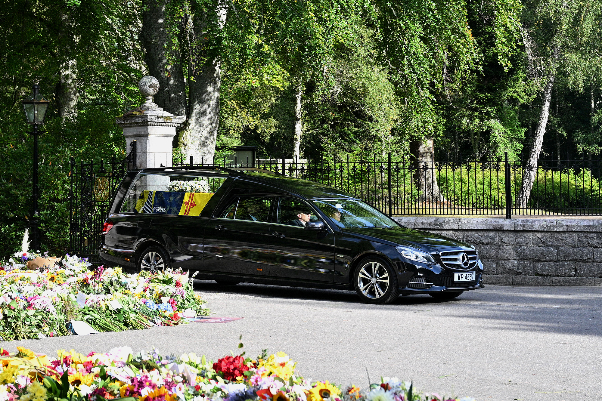 The coffin carrying Queen Elizabeth II is seen leaving Balmoral Castle on September 11, in Aberdeen, Scotland. 