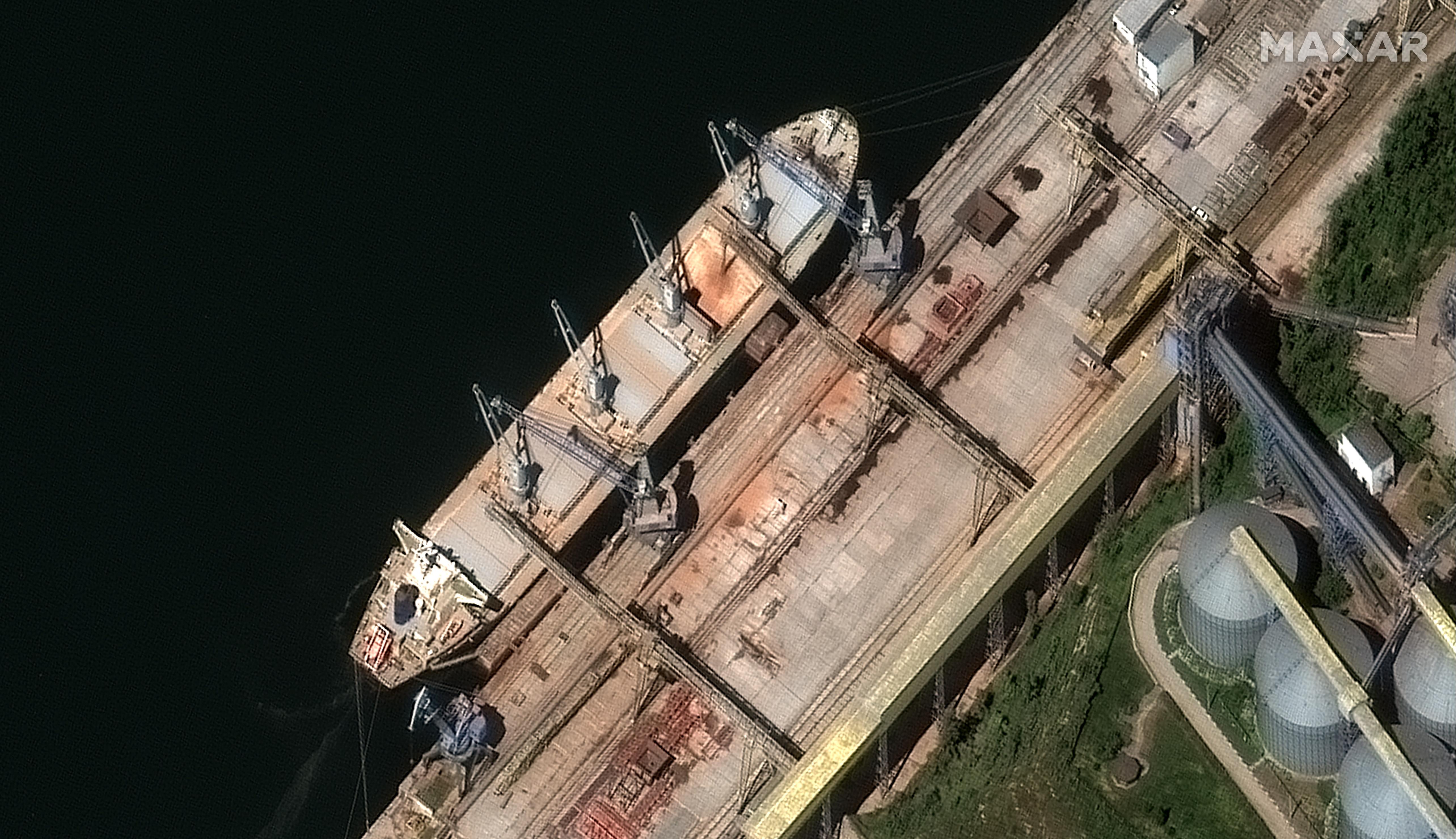 A satellite image from Maxar technologies shows grain being loaded into the hull of the Russia-flagged ship Matros Pozynich in Crimea.