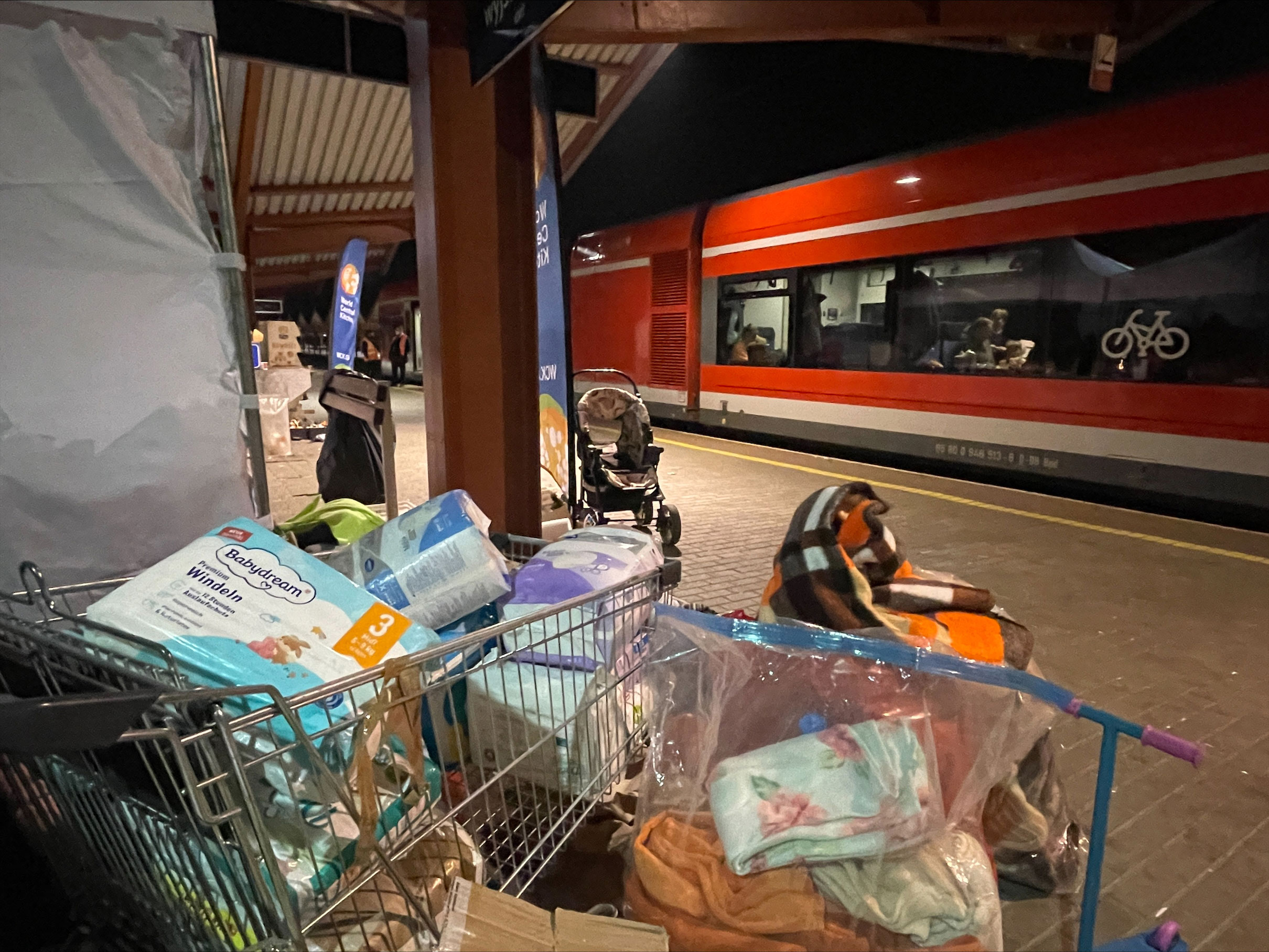 Polish citizens left shopping carts filled with diapers at the Przemyśl train station platform.
