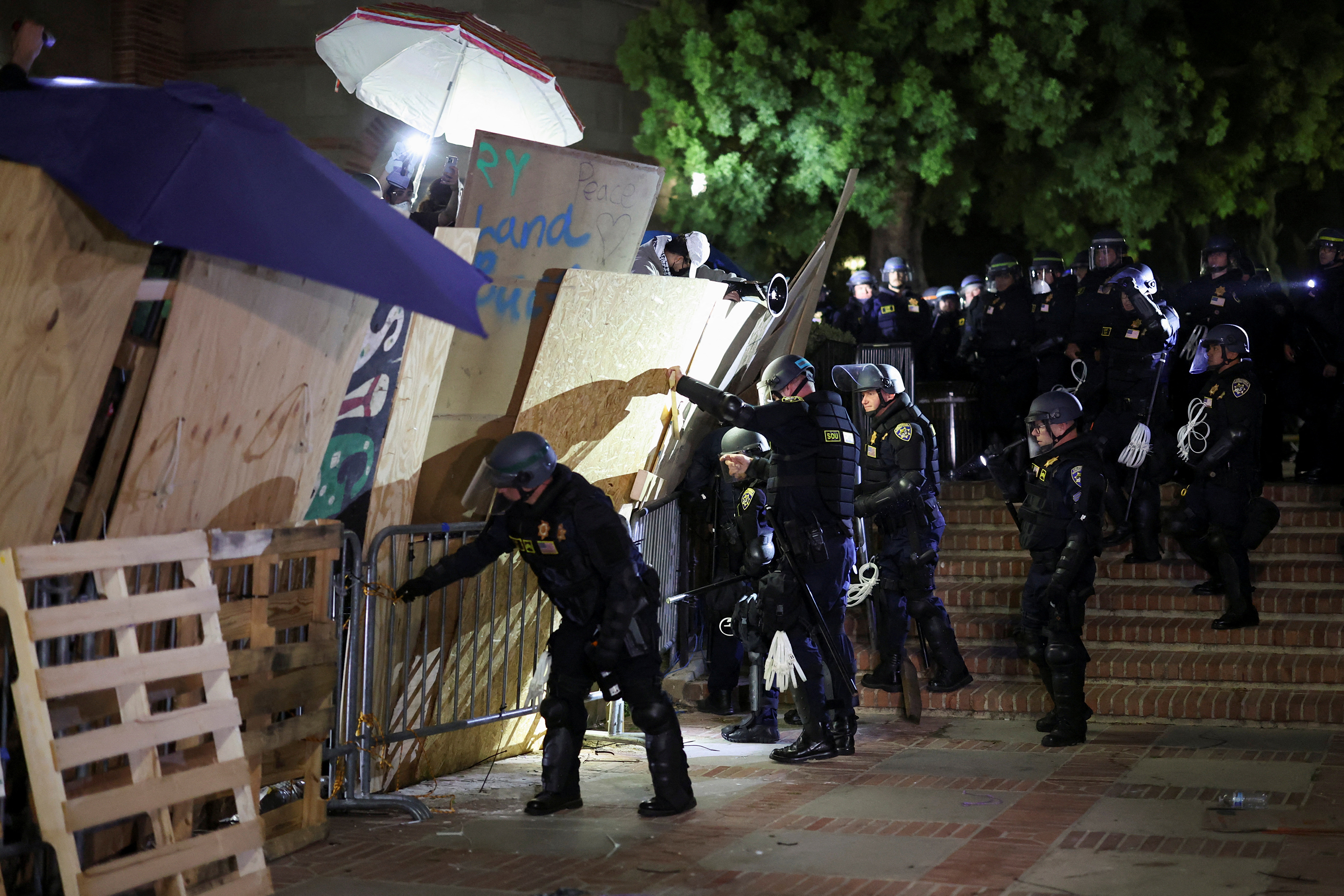 Police take down the barricade around the encampment at the University of California, Los Angeles campus on May 2. 