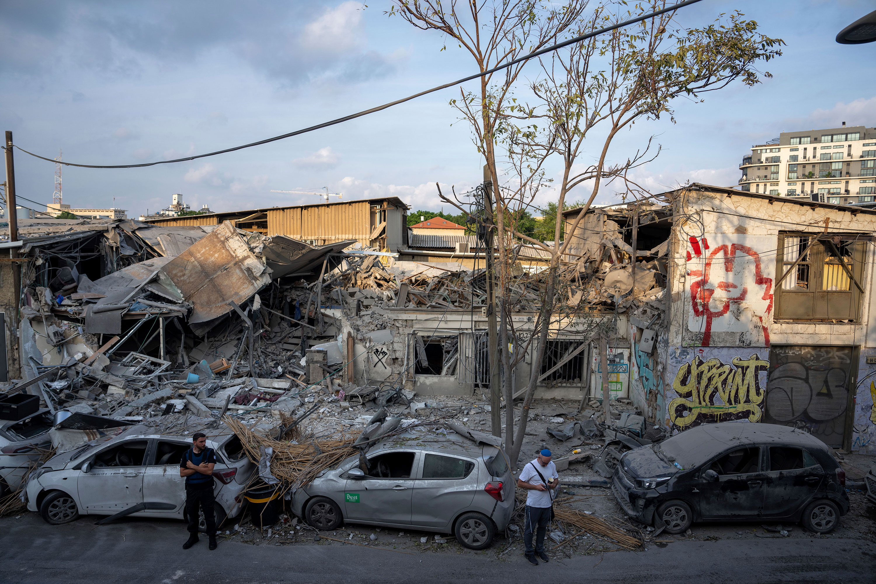 Israelis inspect the rubble of a building in Tel Aviv, Israel, on Sunday, October 8, a day after it was hit by a rocket fired from Gaza.