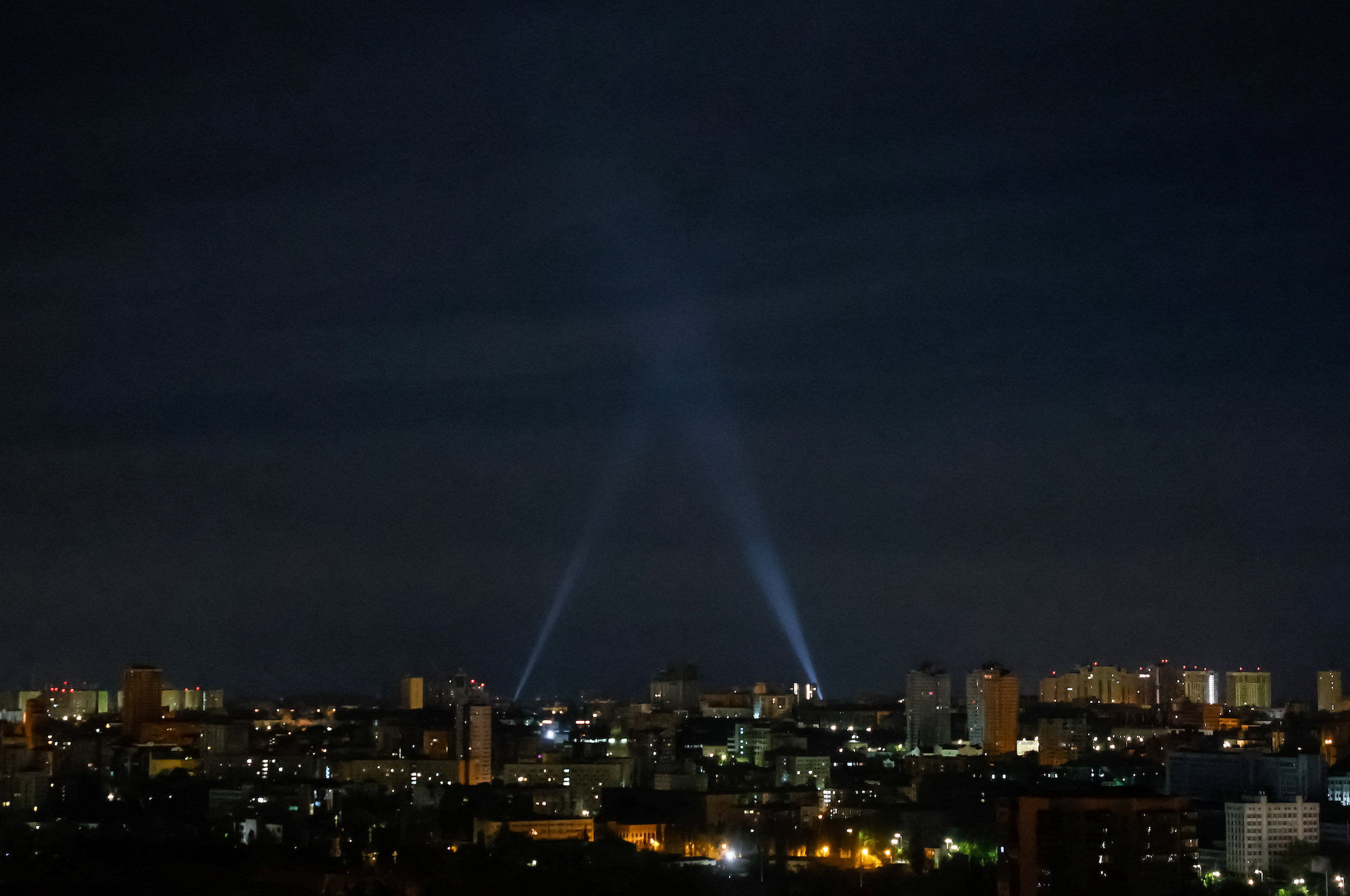 Ukrainian servicemen use spotlights as they search for drones in the sky over the city during a Russian drone strike in Kyiv on Thursday.