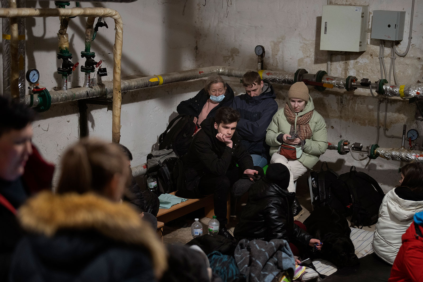 People take shelter in the basement of a building in Kyiv on February 25. 