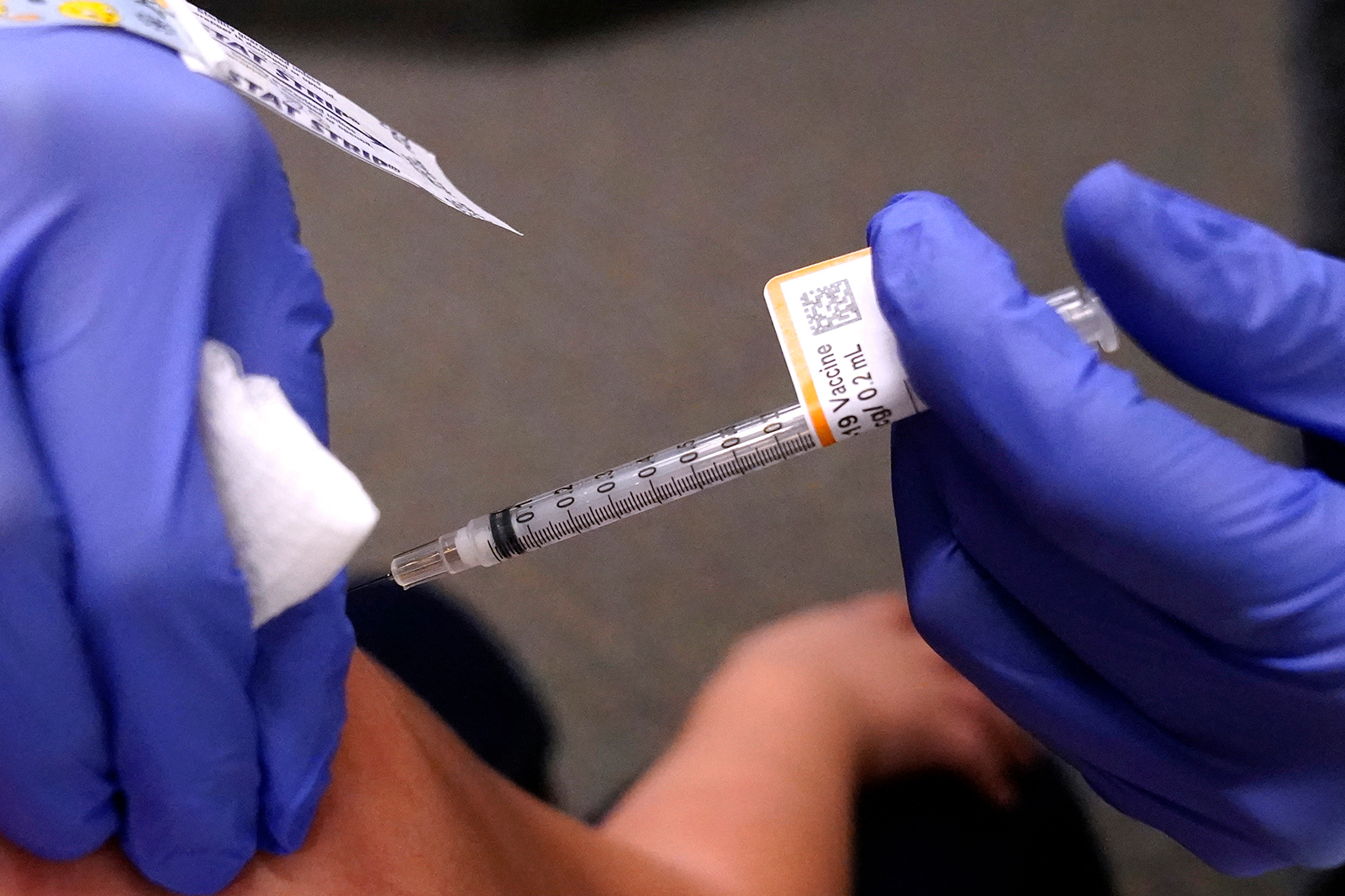 An eight-year-old child receives a second dose of the Pfizer Covid-19 vaccine at Northwest Community Church in Chicago, Saturday, Dec. 11.