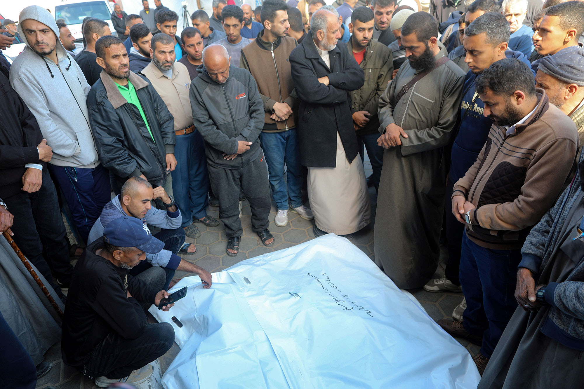Mourners gather next to the bodies of Palestinians, including Hatem Al-Ghamri, mayor of Maghazi, who were killed in an Israeli strike in Gaza on April 9.