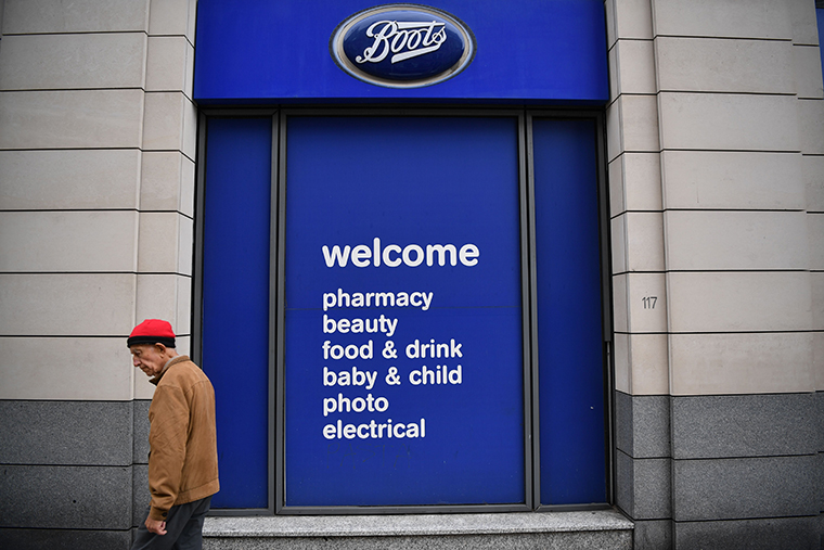 A pedestrian passes a branch of Boots retailer and pharmacy in London on July 9, 2020.