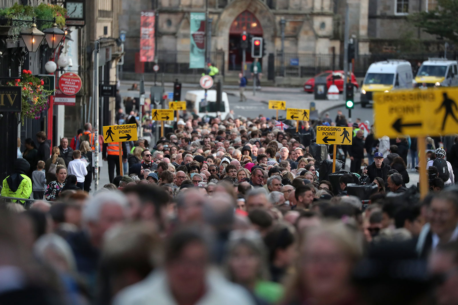 People wait to enter St. Giles' Cathedral to pay their respect to Queen Elizabeth II on Monday, September 12. 