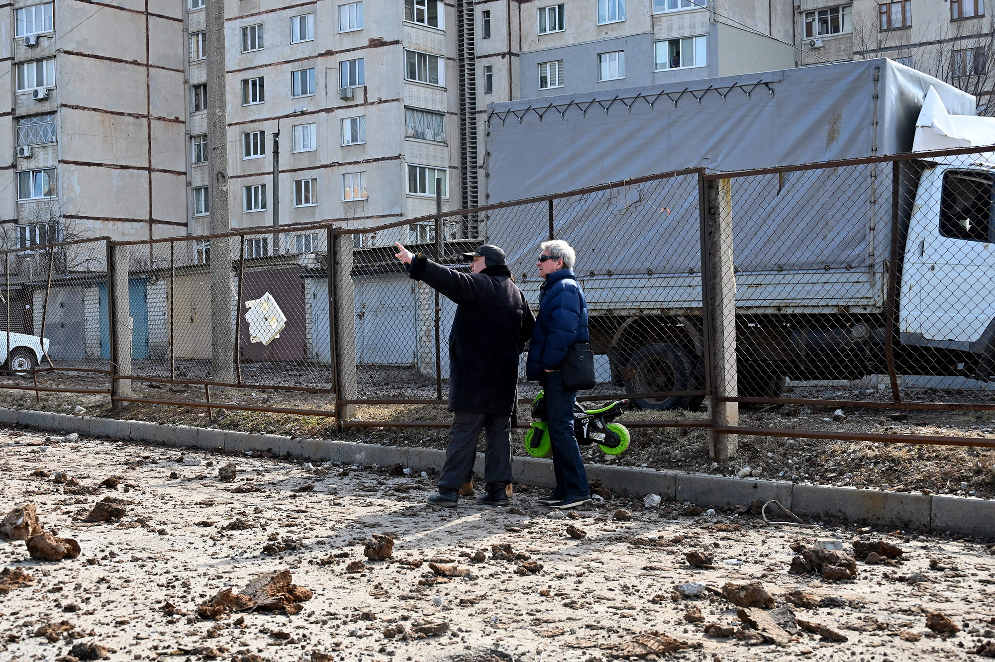 Ukrainian residents stand amid debris after a Russian missile strike in the city of Kharkiv, Ukraine, on March 15.