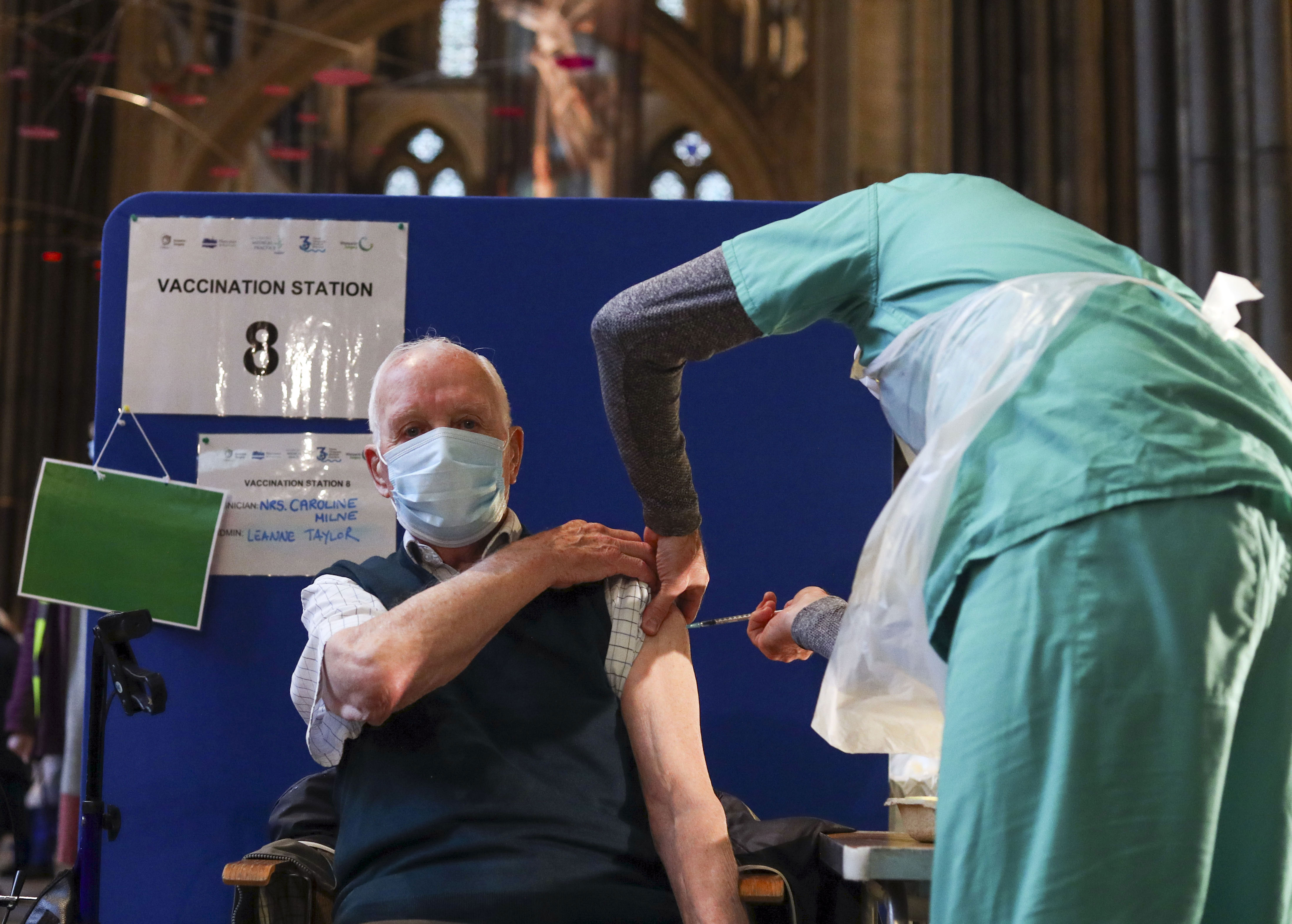 Louis Godwin, a former Royal Air Force flight sergeant, receives an injection of the Pfizer/BioNTech Covid-19 vaccine at Salisbury Cathedral in England on January 16.