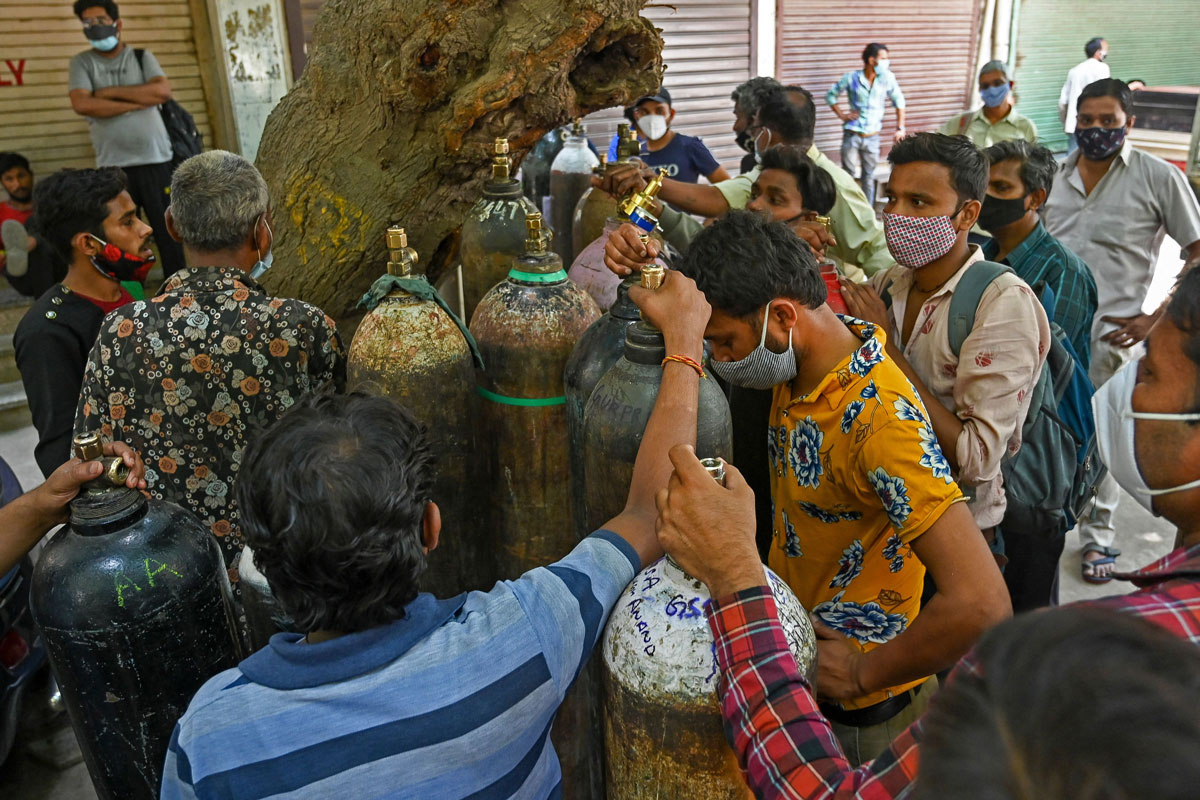 People wait in line to refill their medical oxygen cylinders for Covid-19 patients under home quarantine in New Delhi, India on May 4.