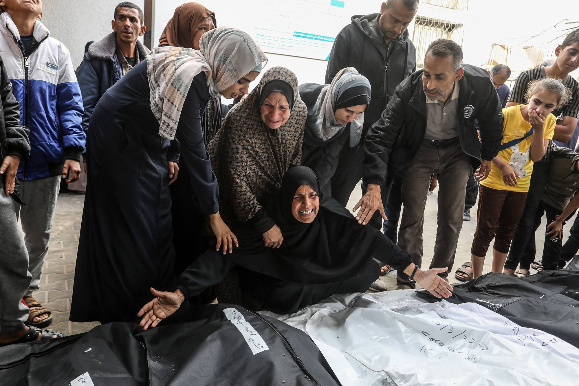 Relatives of Palestinians who lost their lives as a result of Israeli airstrike mourn as they take the bodies from the morgue of El-Najar Hospital, Gaza, on April 21.