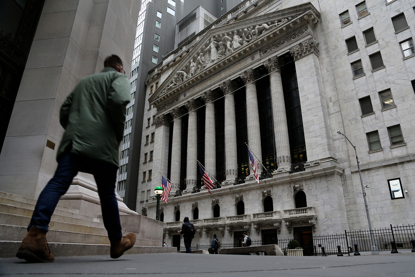 People pass the front of the New York Stock Exchange in New York on March 22.
