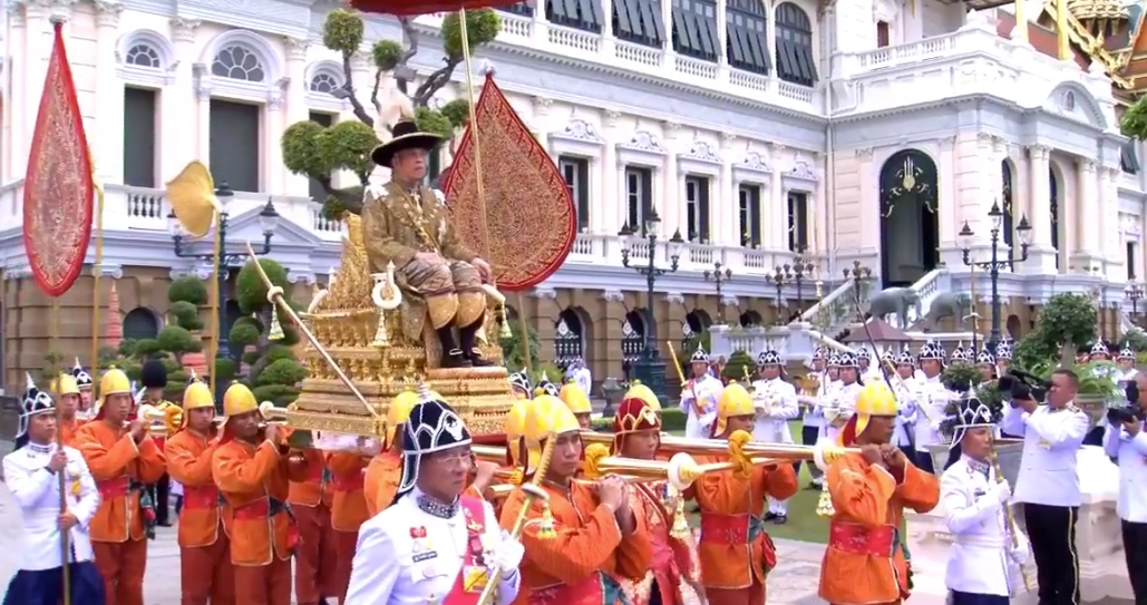 The Thai King rides on the royal palanquin as part of his final event of the day.