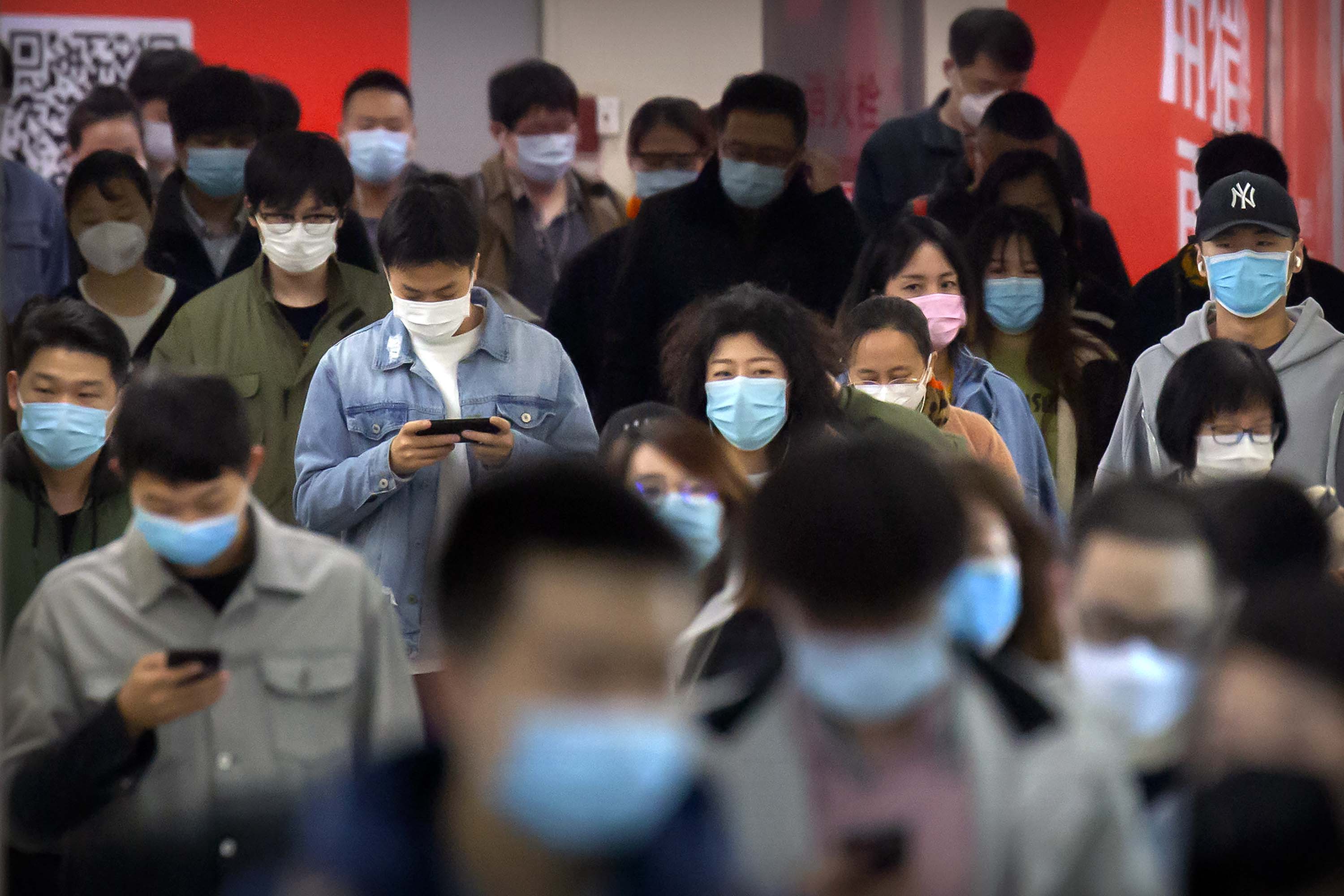Commuters make their way through a subway station in Beijing, China on April 9.