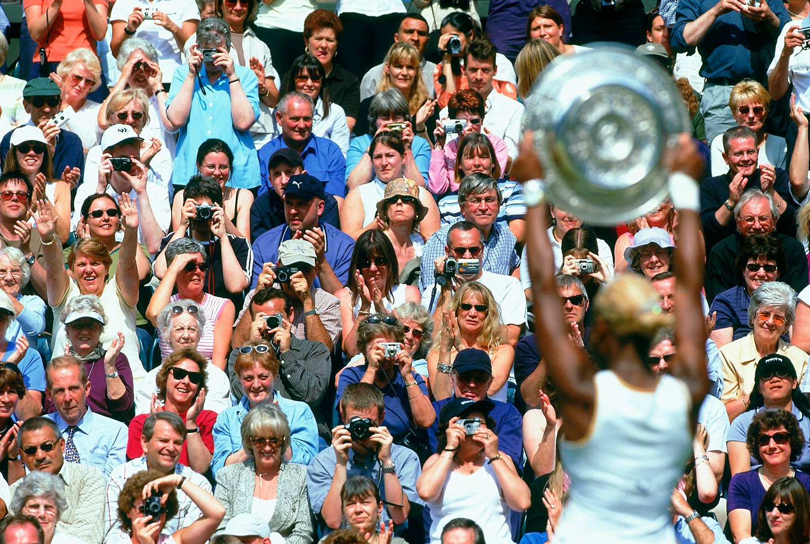 Serena Williams poses with the trophy after winning her first Wimbledon title in 2002. She was No. 1 in the world at the age of 20.