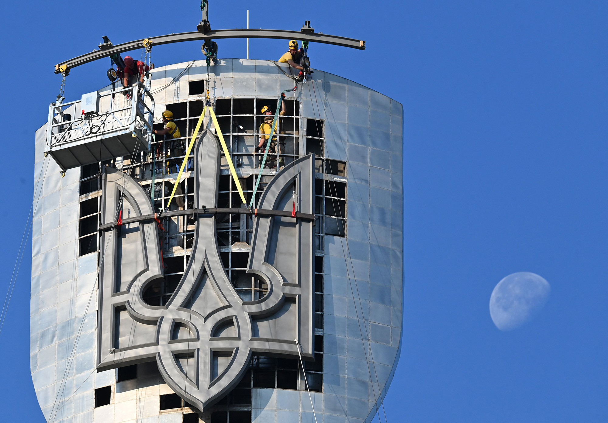 Steeplejacks operate to install the Ukrainian official coat of arms replacing the coat of arms of the former Soviet Union which was previously removed from the Motherland Monument in Kyiv, Ukraine, on August 6.