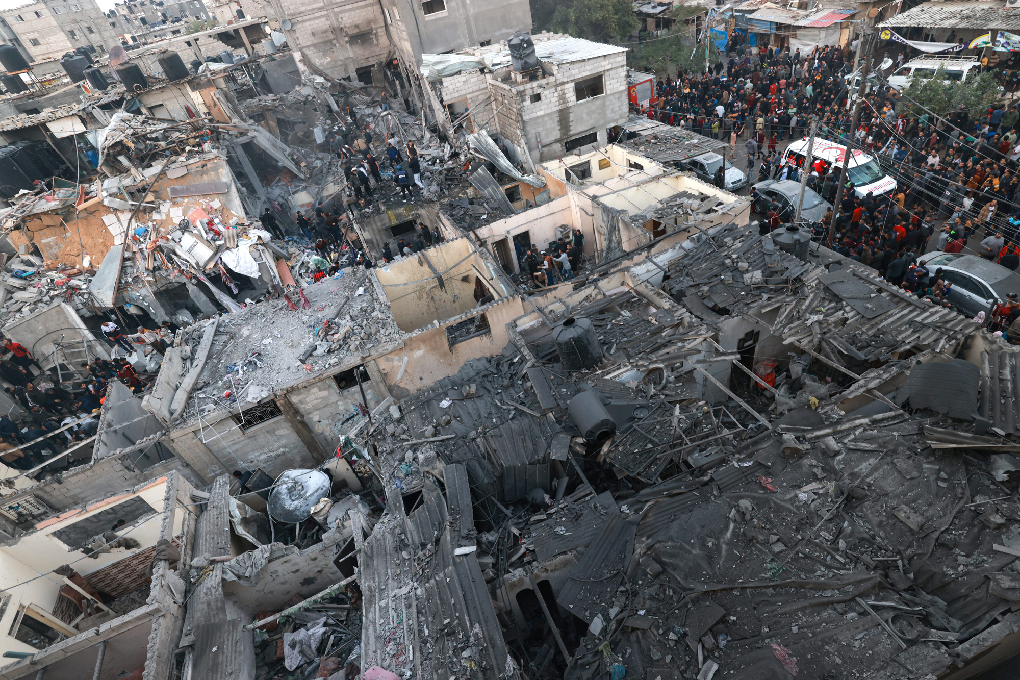 Palestinians check the destruction following Israeli bombardment in Rafah, southern Gaza, on December 12.