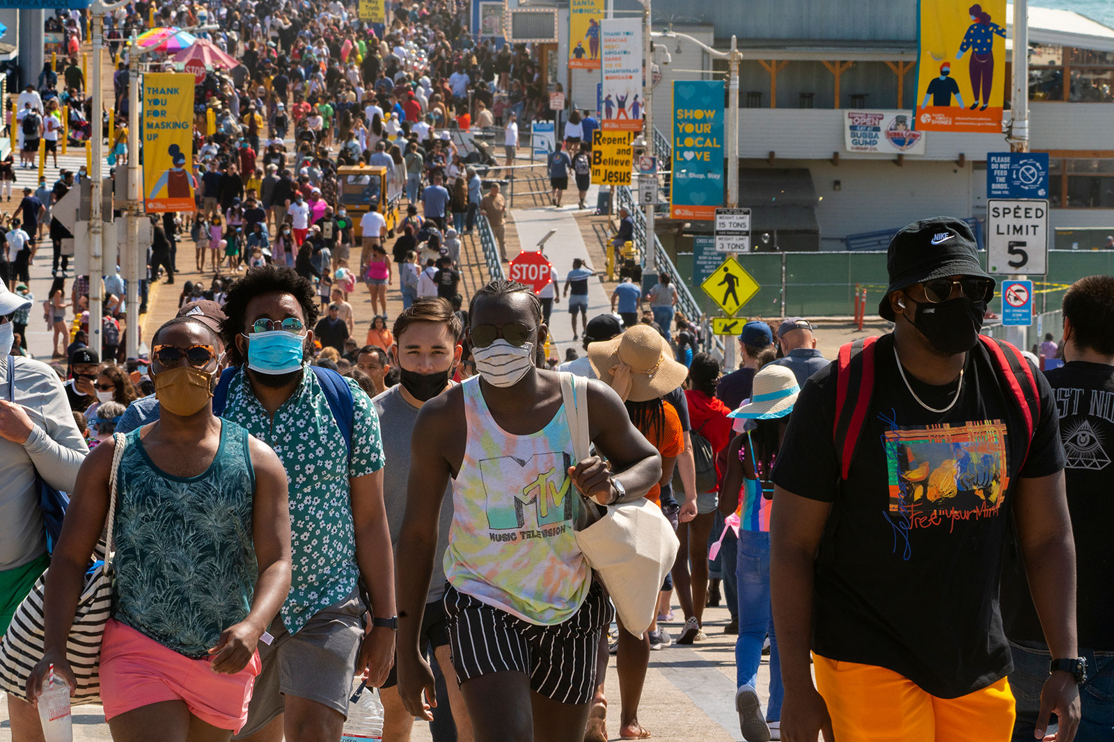 People walk along the Santa Monica Pier in California on Saturday, May 29.