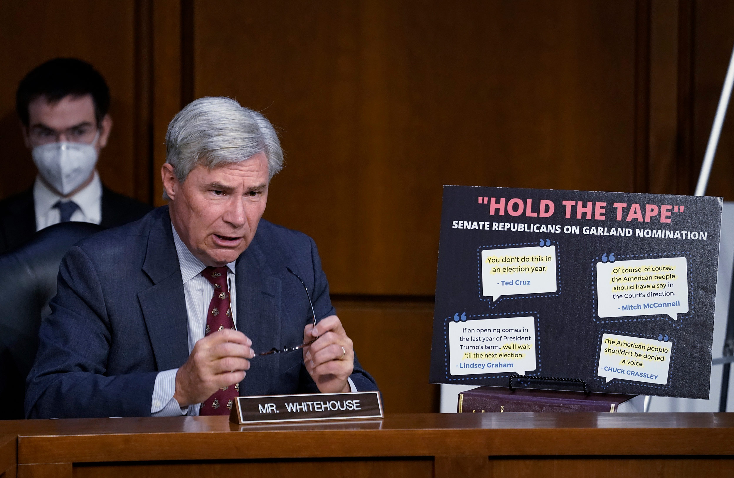 Sen. Sheldon Whitehouse speaks while displaying a sign during Supreme Court nominee Judge Amy Coney Barrett's confirmation hearing before the Senate Judiciary Committee on Capitol Hill in Washington, DC, on October 13.