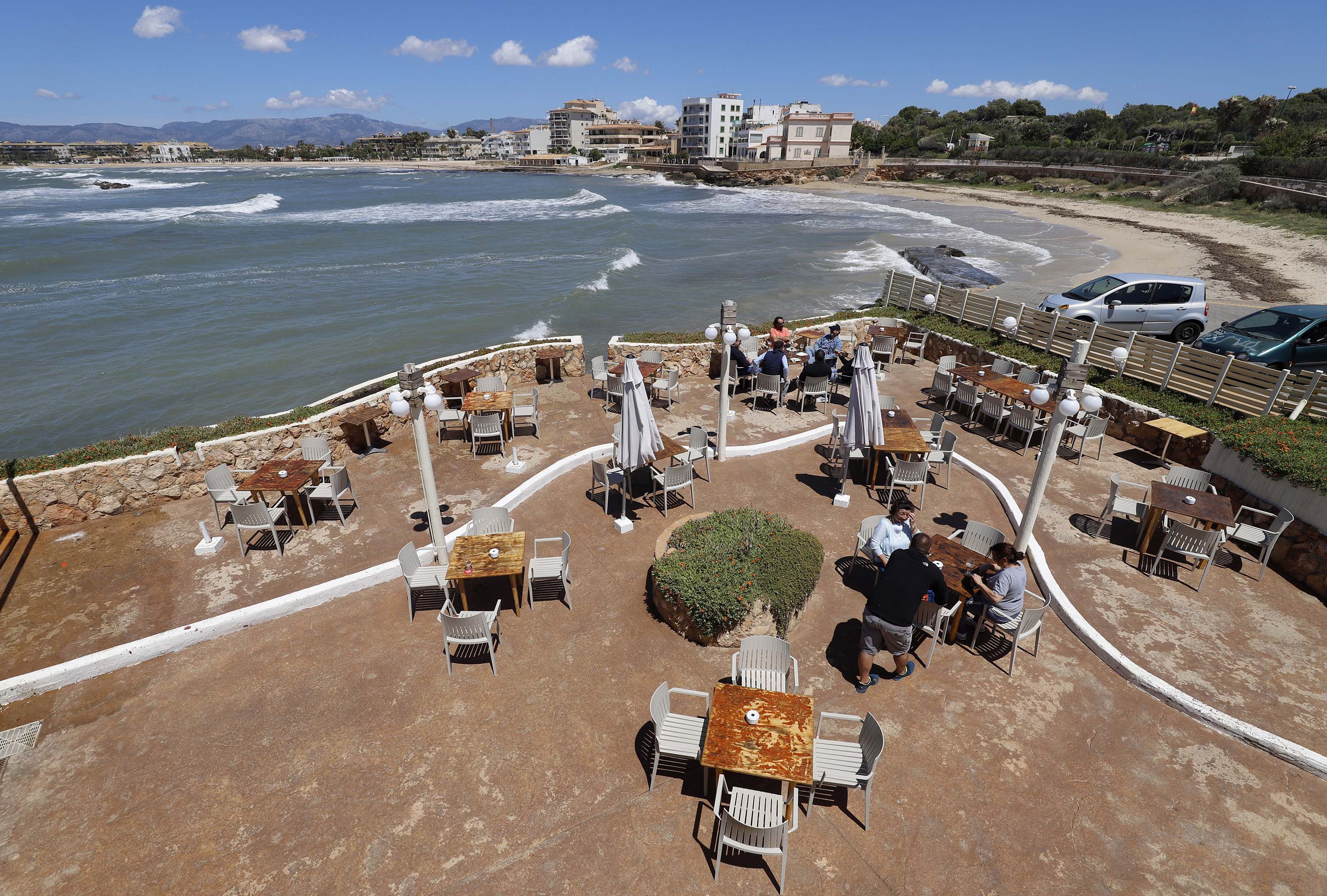 People sit on the terrace of the bar El Pe-on in Mallorca, Spain, on Monday, May 11. 