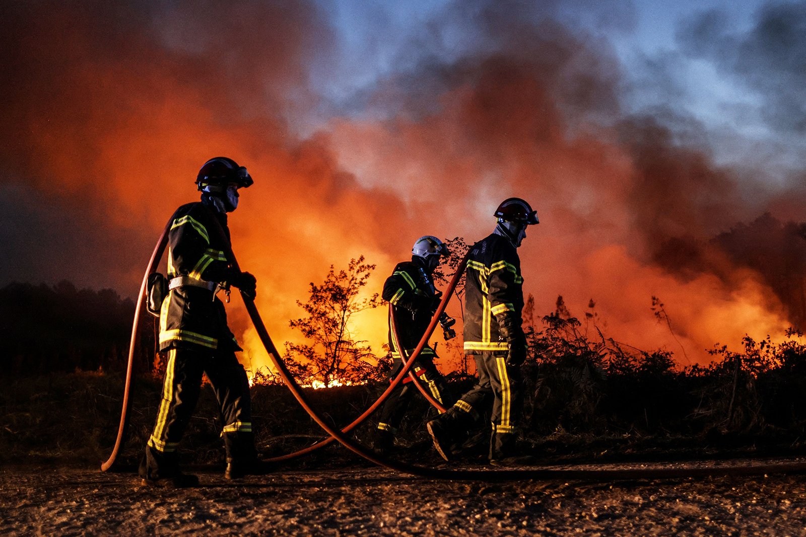 Firefighters try to control a forest fire in Louchats, in the Gironde area of southwestern France, on July 17.