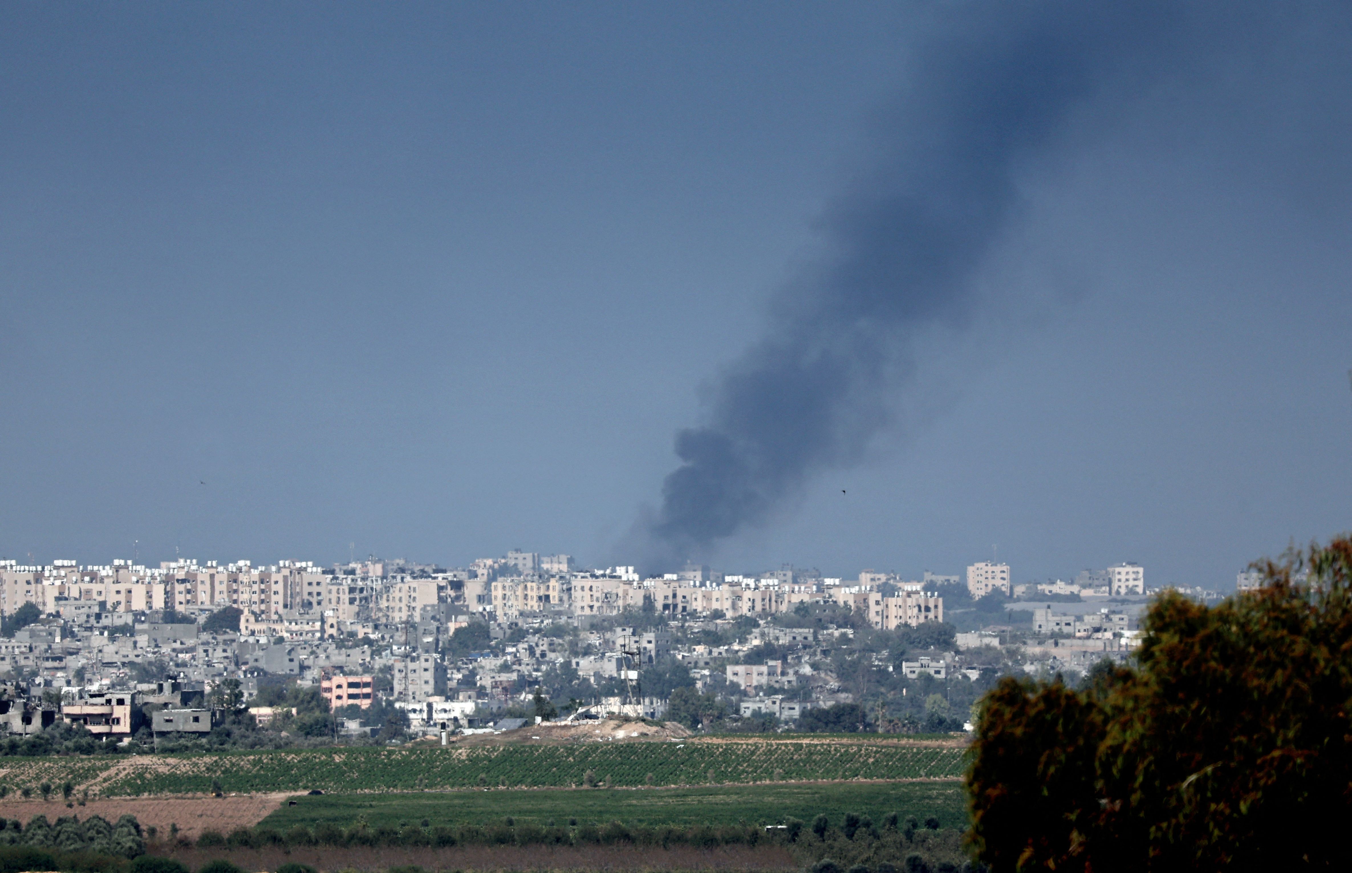 Picture taken from the Israeli city of Sderot shows black smoke rising from Gaza, on October 14, 2023.