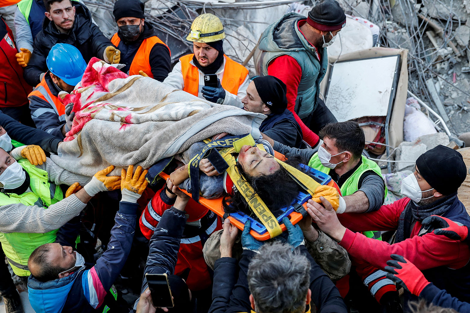 Rescuers carry 27-year-old survivor Rabia Ofkeli in the aftermath of a deadly earthquake in Hatay, Turkey, on Friday. 