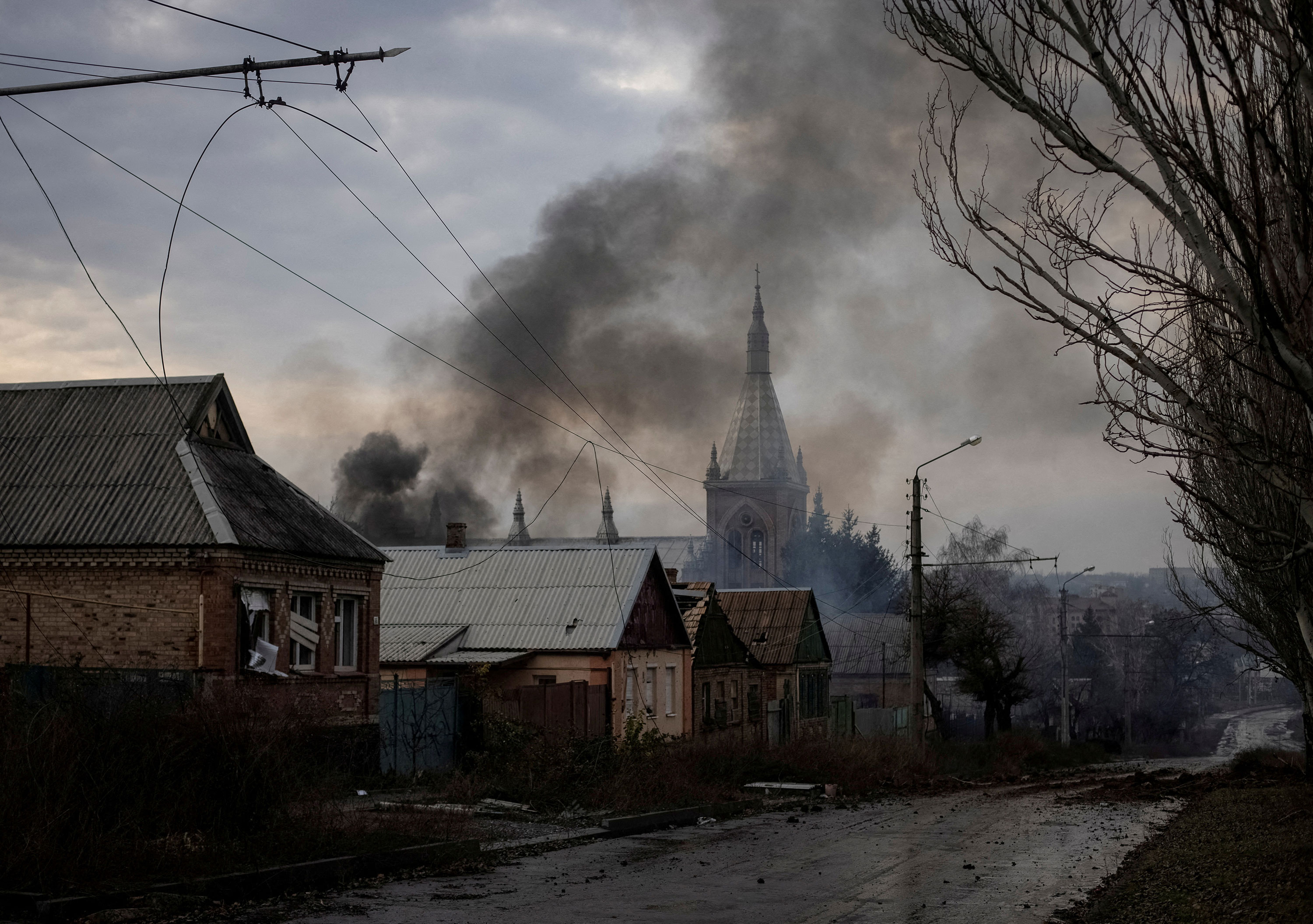 Smoke rises near houses damaged by a Russian military strike in Bakhmut on December 9.