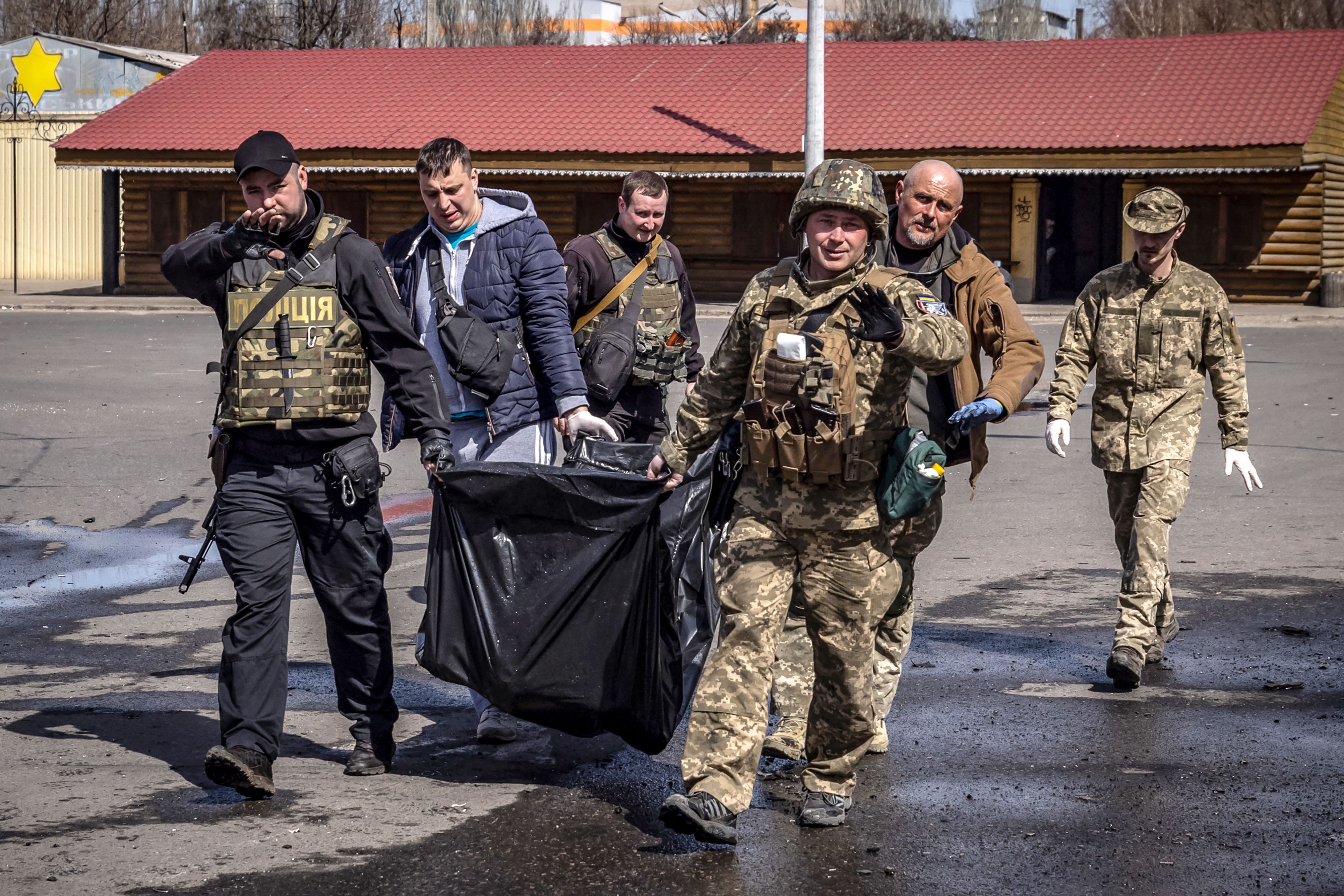 Ukrainian soldiers clear out bodies after a rocket attack at a train station in Kramatorsk, eastern Ukraine, on April 8.