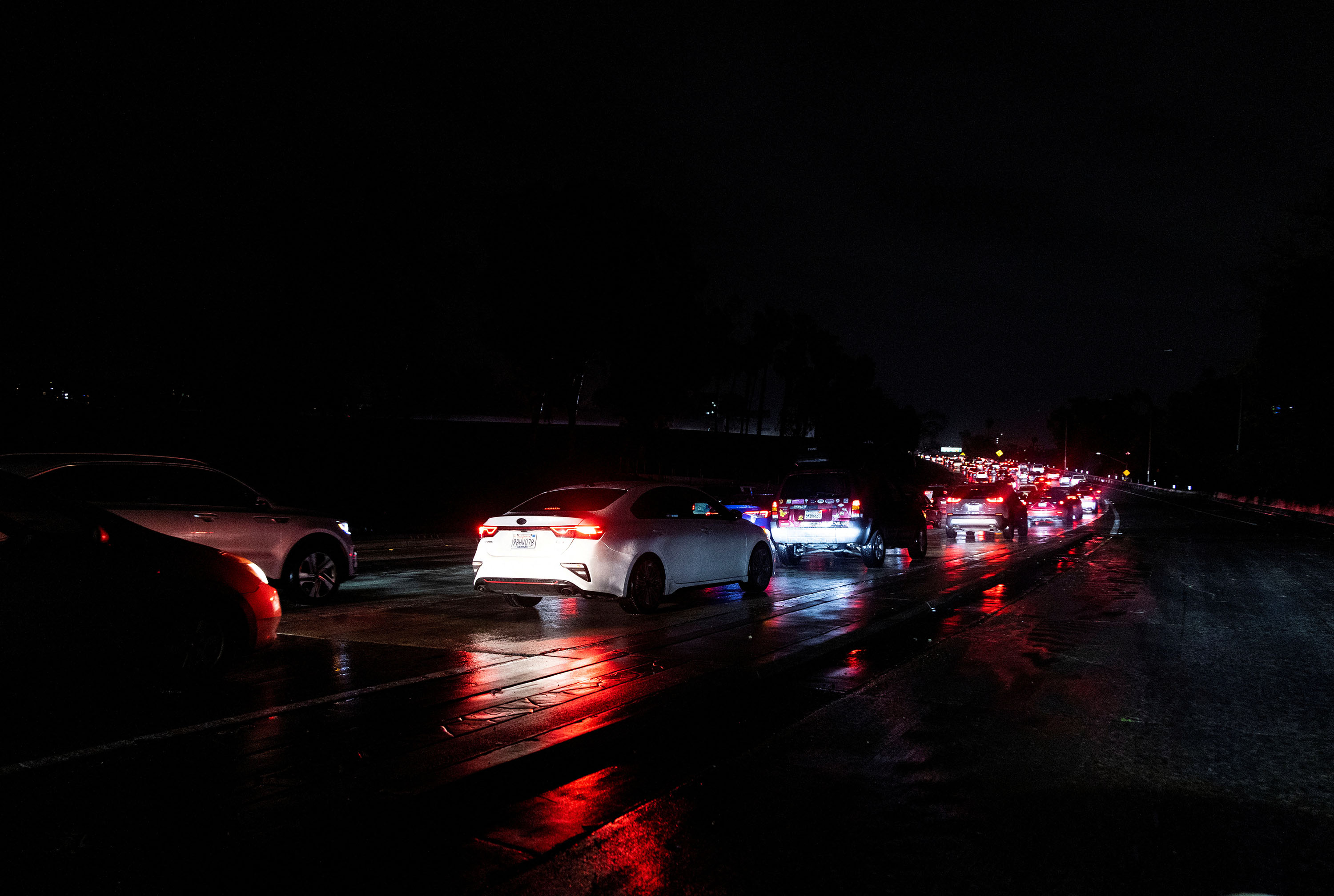 Cars drive on Highway 101 during a rain storm in Los Angeles on February 5. 