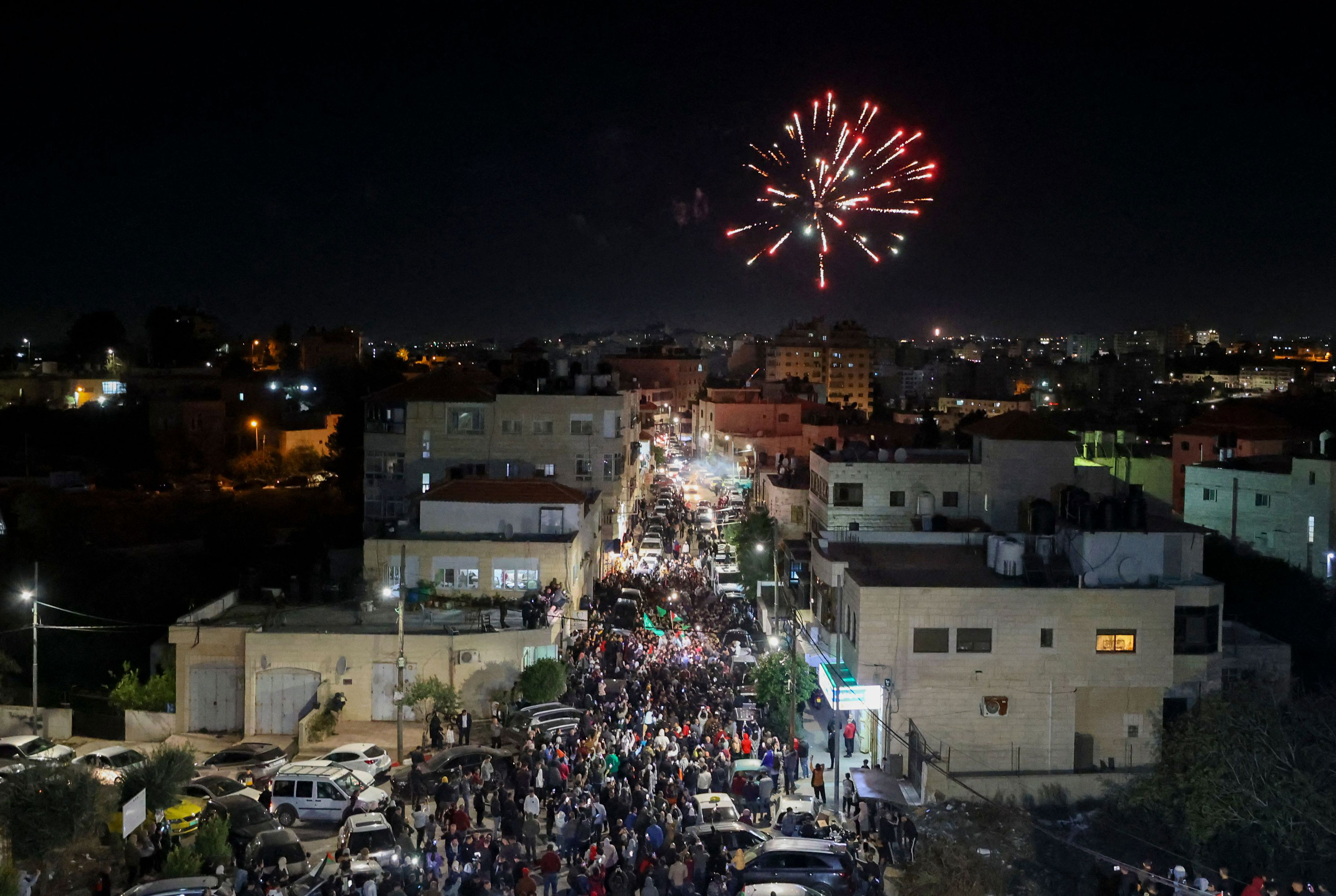 Fireworks streak across the sky as Palestinian prisoners that were released from the Israeli Ofer military facility are paraded in Beitunia, in the occupied West Bank, on Friday. 
