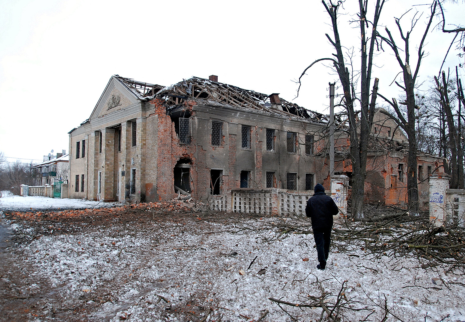 A man walks in front of a building damaged by recent shelling in Kharkiv, Ukraine, on March 6.